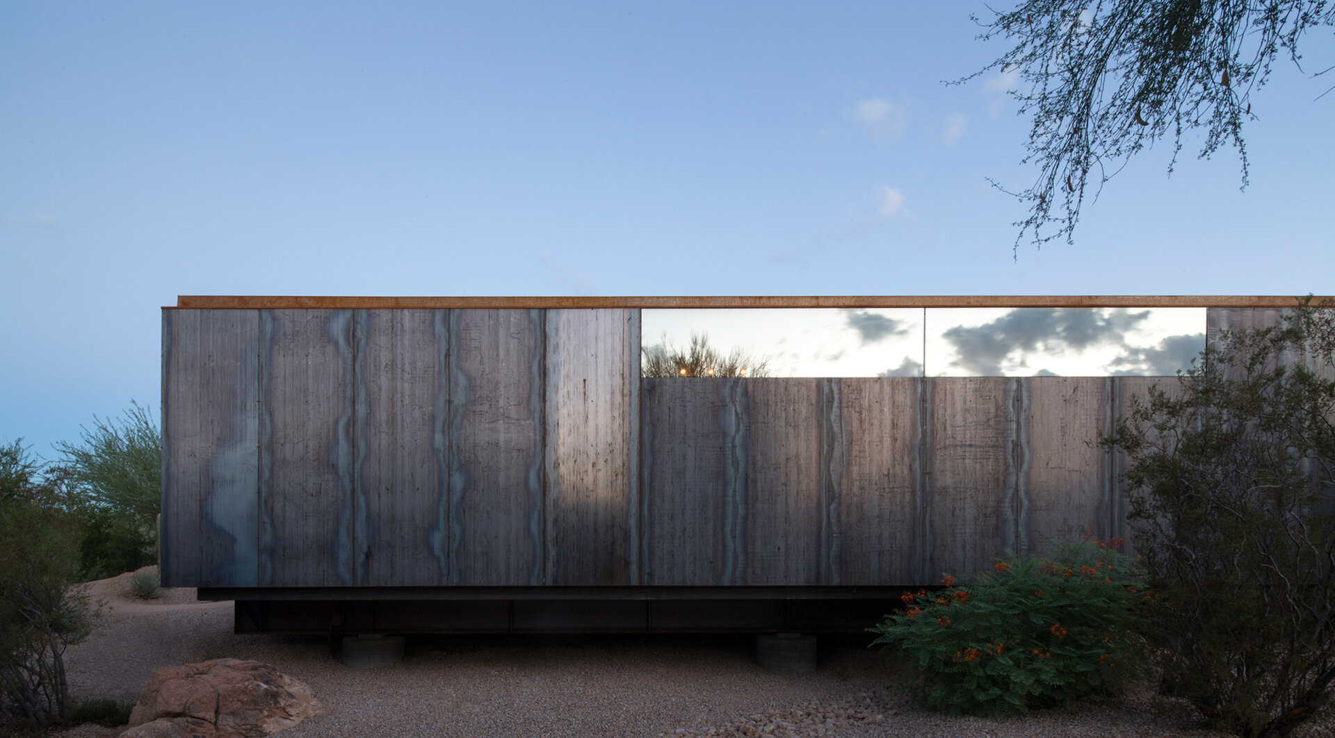 This art studio floats above a desert wash, supported by only six concrete caissons to minimize environmental impact.