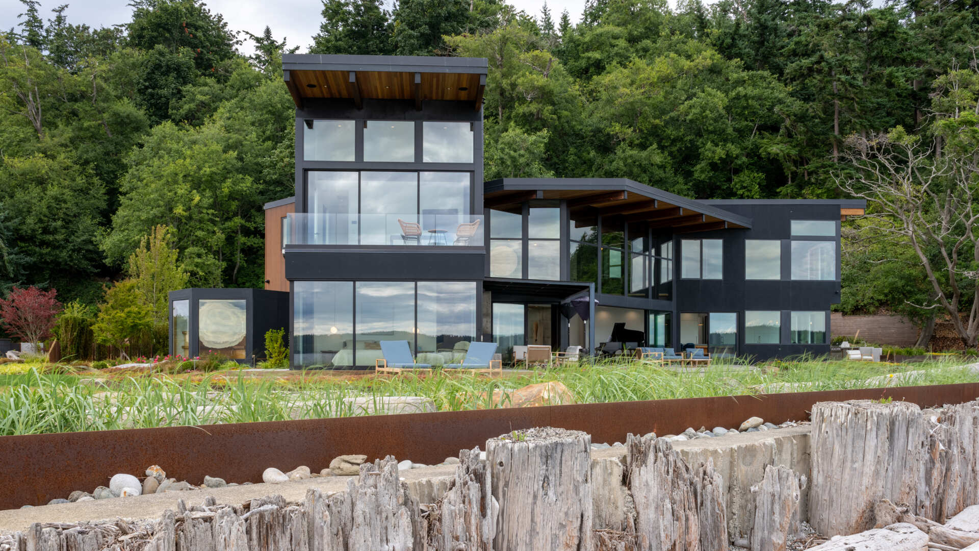 This coastal home shows how architecture can respond directly to land, regulation, and risk. Designed within an existing footprint, the form reflects shoreline rules, steep slopes, and long term durability in a marine environment.
