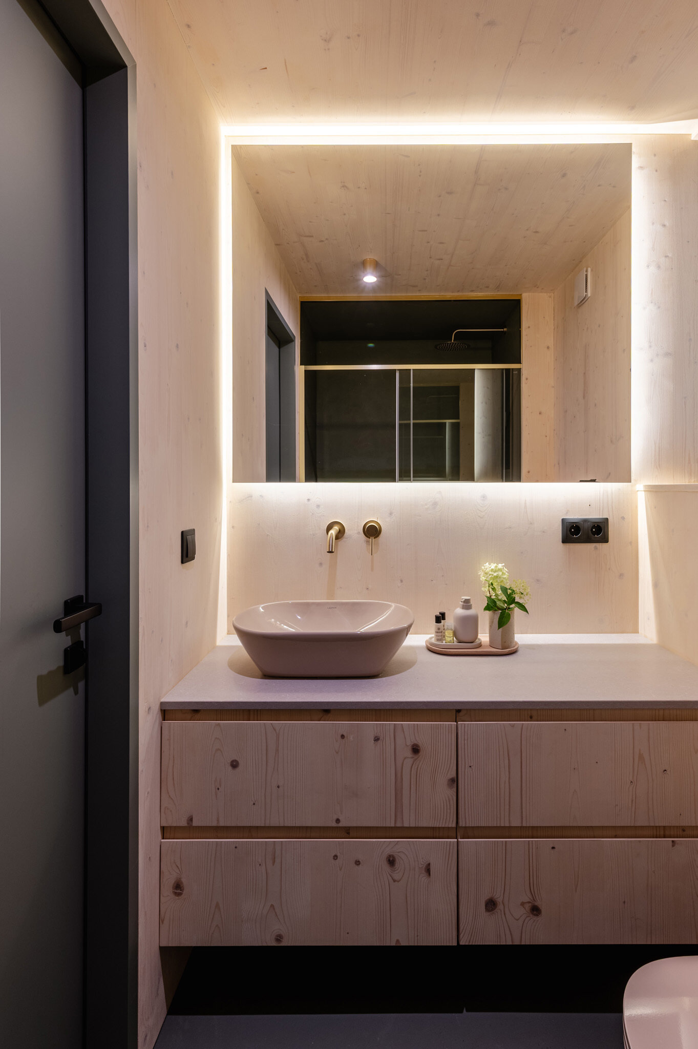 Minimal bathrooms with wood finishes.