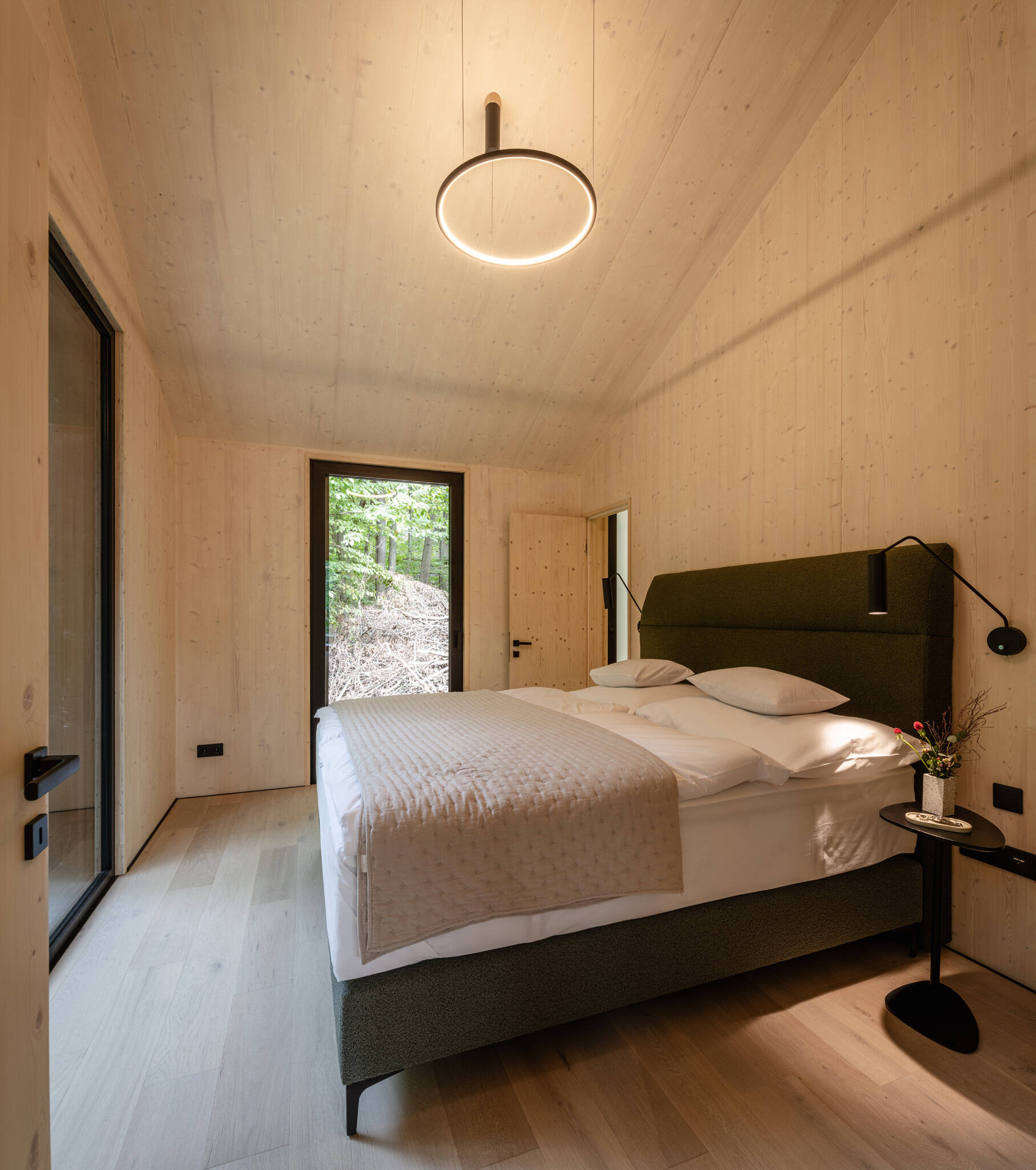A calm bedroom shaped by timber, light, and a quiet material palette.
