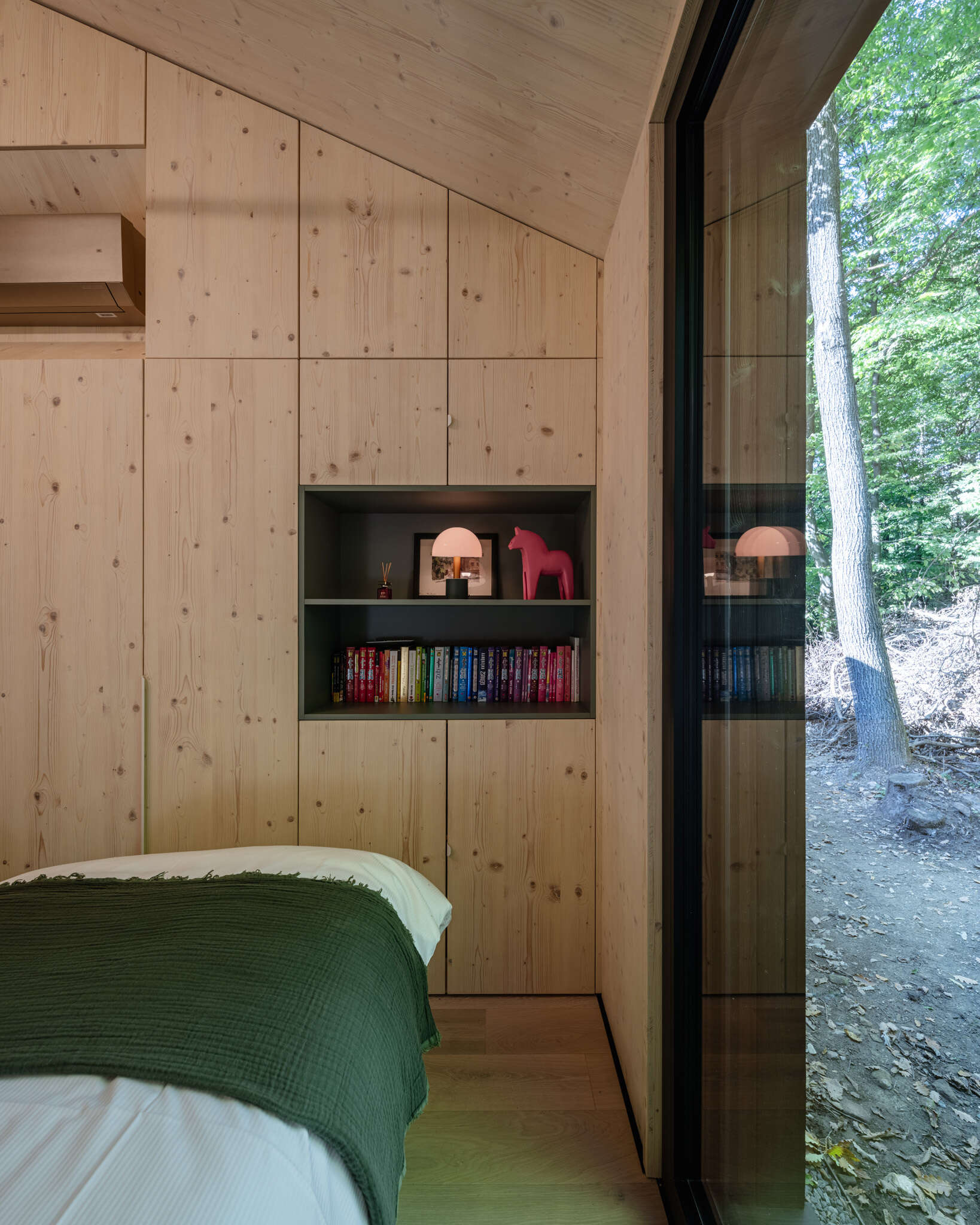 A calm bedroom shaped by timber, light, and a quiet material palette.
