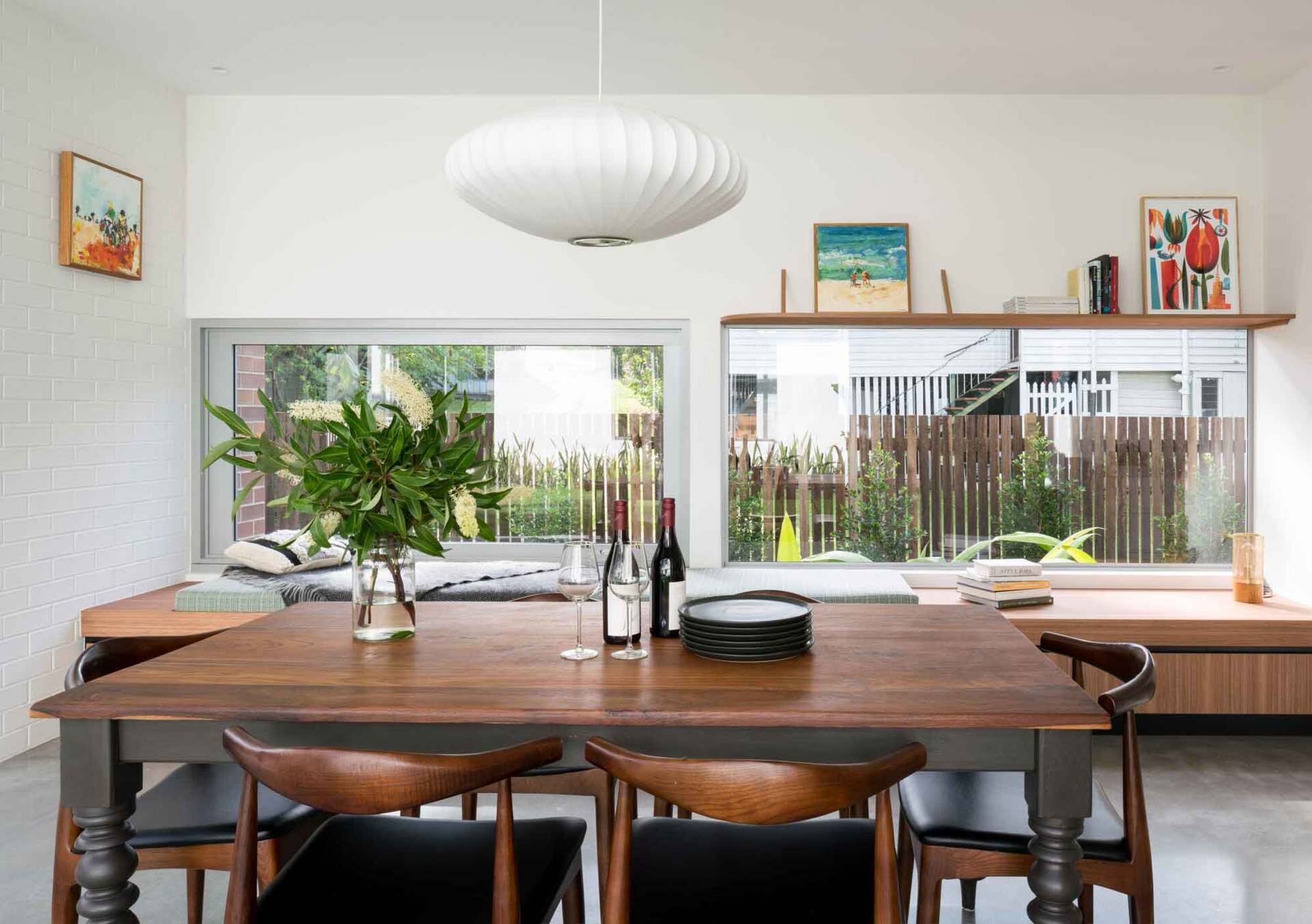 A timber bench beside the windows turns the dining area into a relaxed place to enjoy natural light.