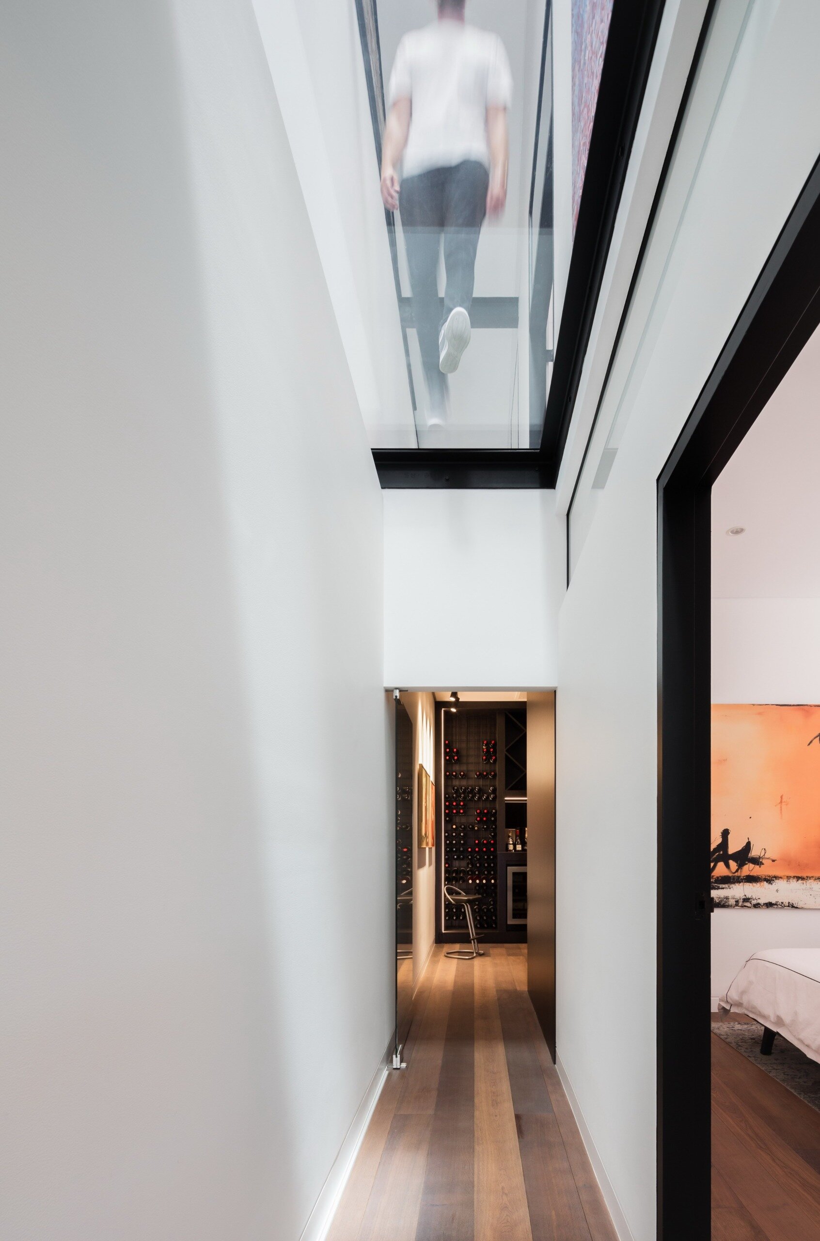 Natural light and elevated views turn this lower level hallway into more than just a passage.