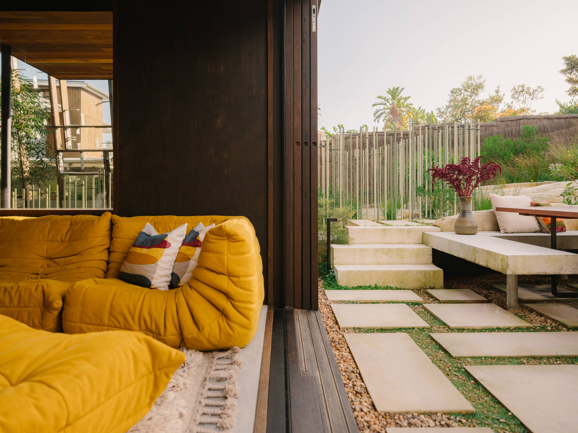 A casual living room with direct access to the garden and outdoor dining area.