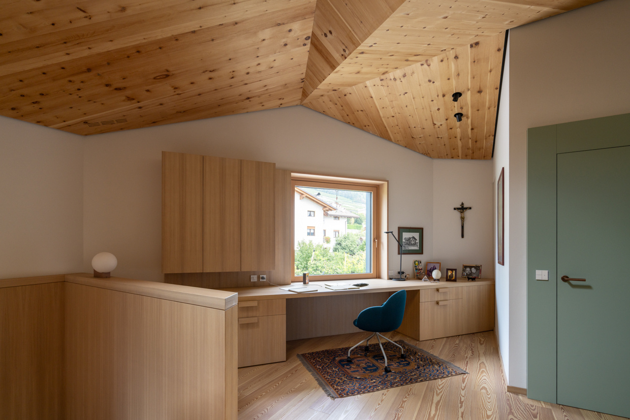 A wood clad stair and built in desk define an upper level study filled with light and cedarwood warmth.