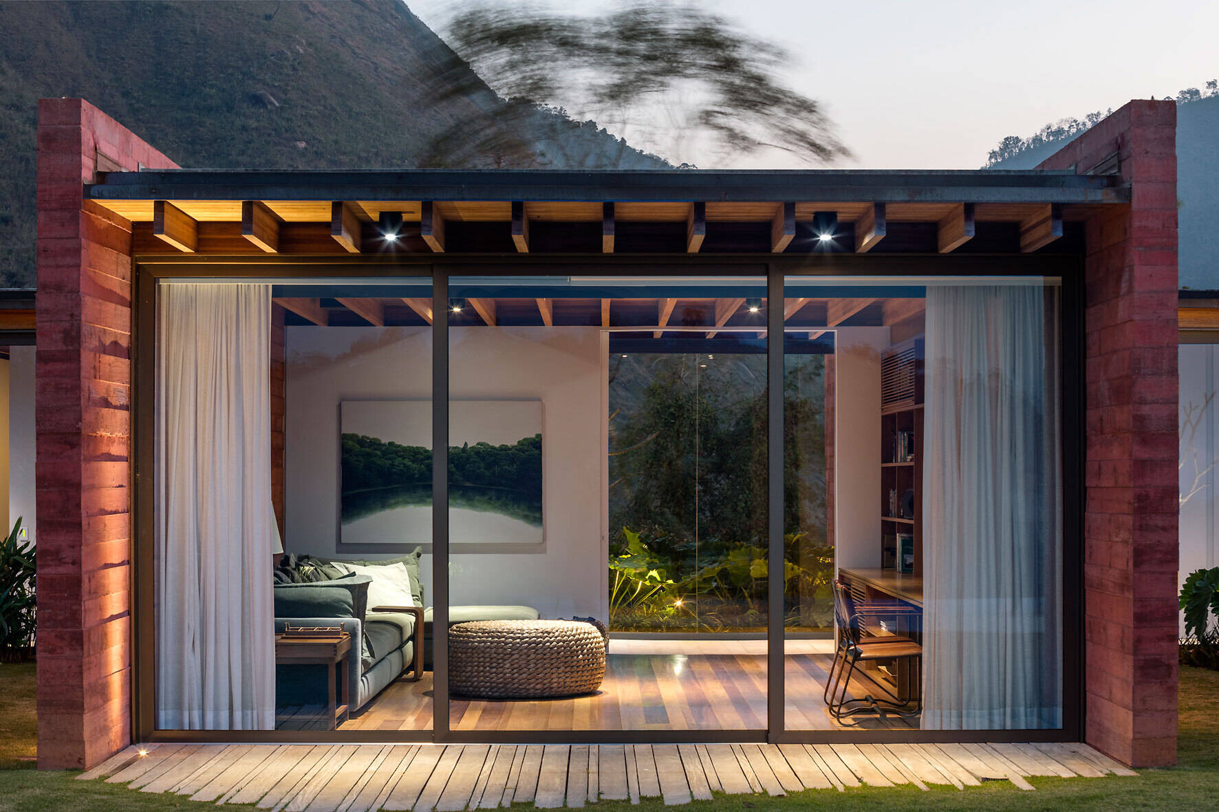 The home office at Casa Terra extends from the main hallway, combining work space with a relaxed lounge feel.