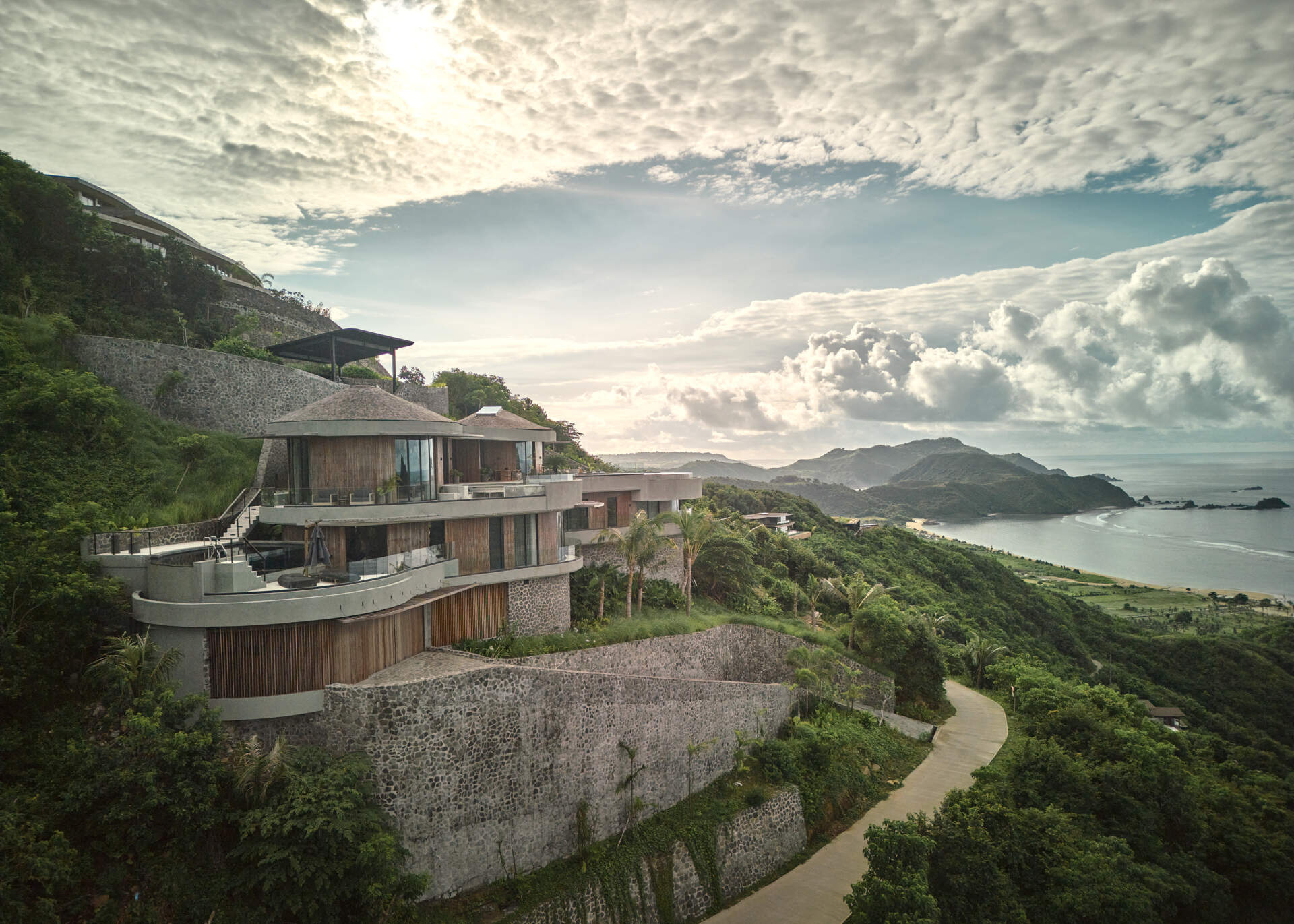 This hillside house steps down one of Tampah Hills’ steepest slopes, using circles and tangents to shape space and circulation.
