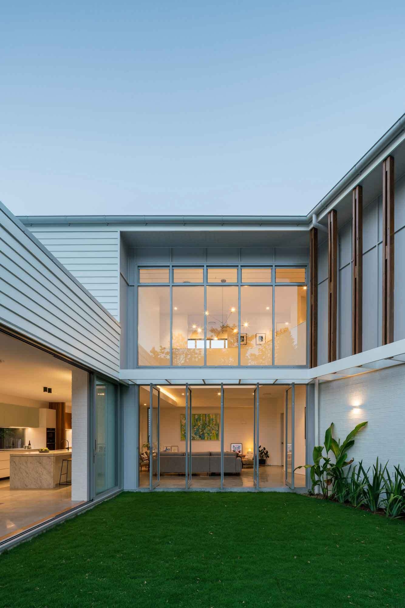 Pivoting glass doors blur the line between inside and outside, allowing light and breezes to flow through.