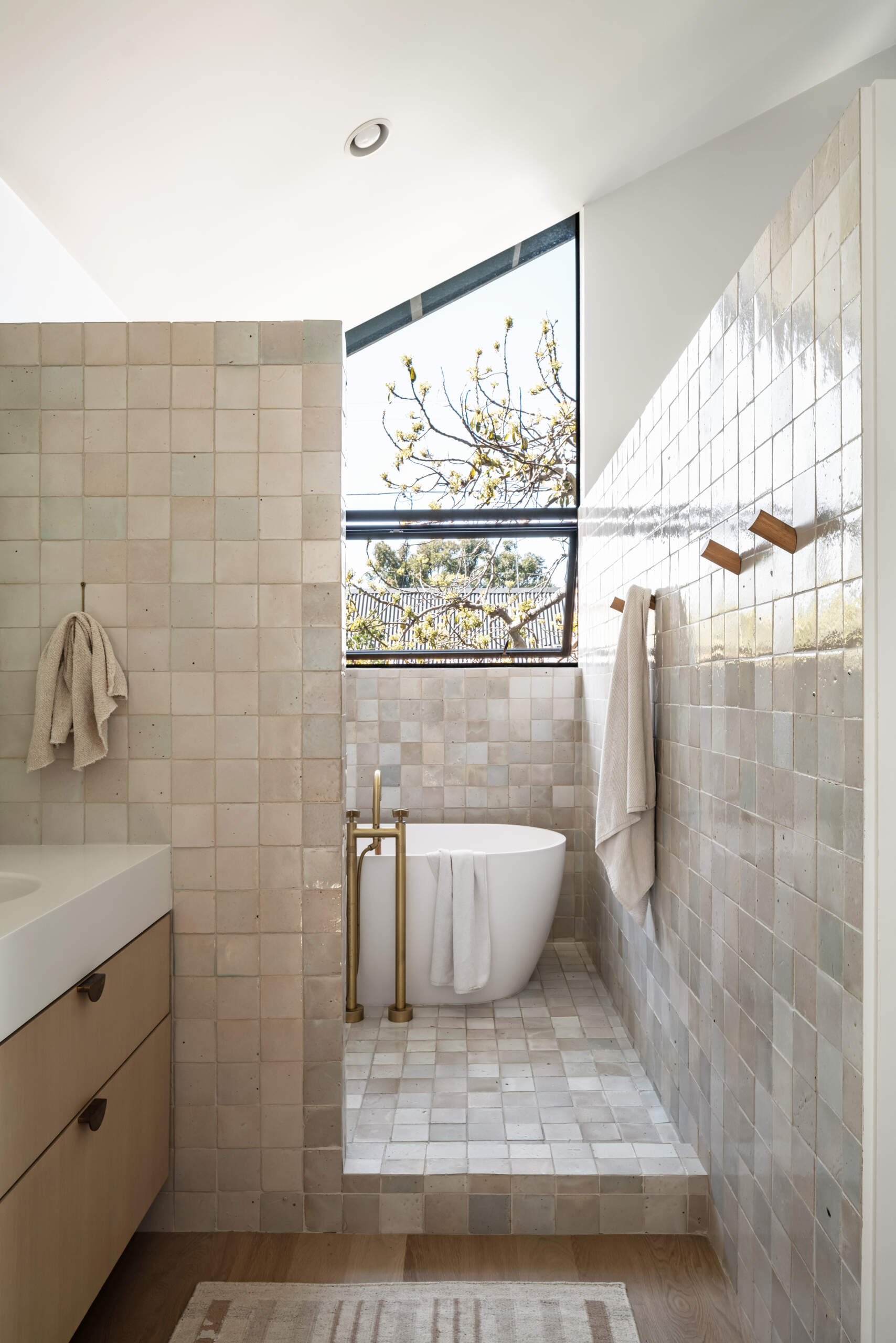 This modern bathroom has a restrained material approach with ceramic tile and clean surfaces. The focus remains on durability and consistency rather than decorative excess, aligning with the home’s overall philosophy.