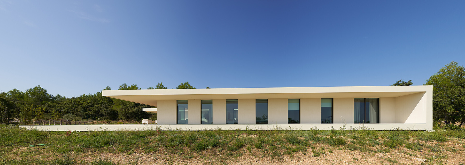 This French home is divided into three separate buildings, creating a calm architectural rhythm that blends into its surroundings.