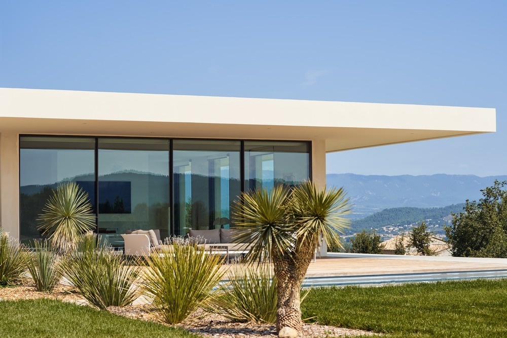 This French home is divided into three separate buildings, creating a calm architectural rhythm that blends into its surroundings.