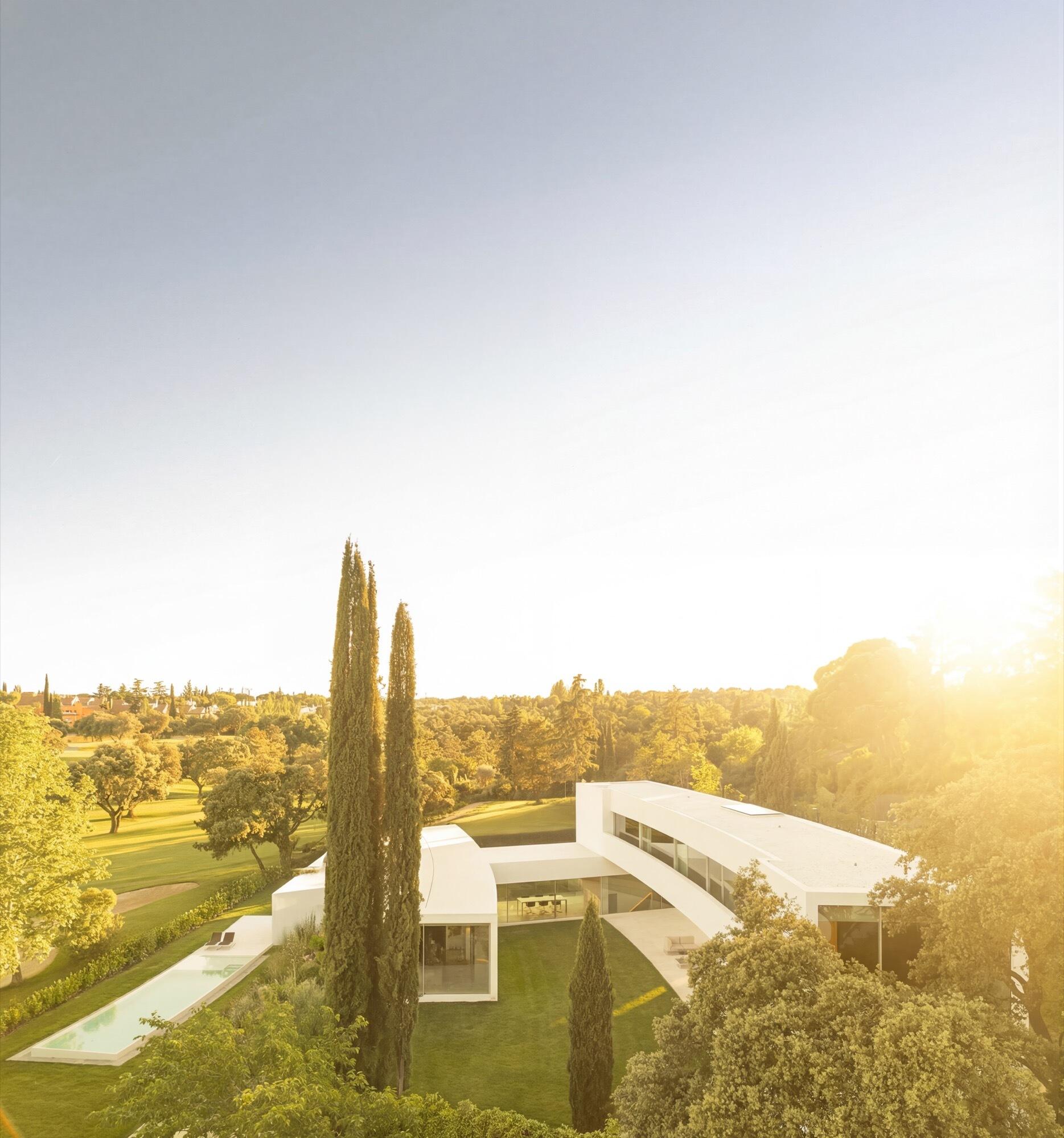 Architecture made from long curved volumes arranged in sequence, shaping circulation and movement throughout this Madrid house by Fran Silvestre Arquitectos.