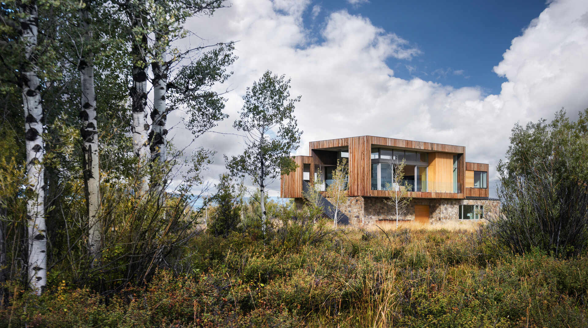 Earthen rock and stained wood connect this contemporary home to its natural Idaho surroundings.