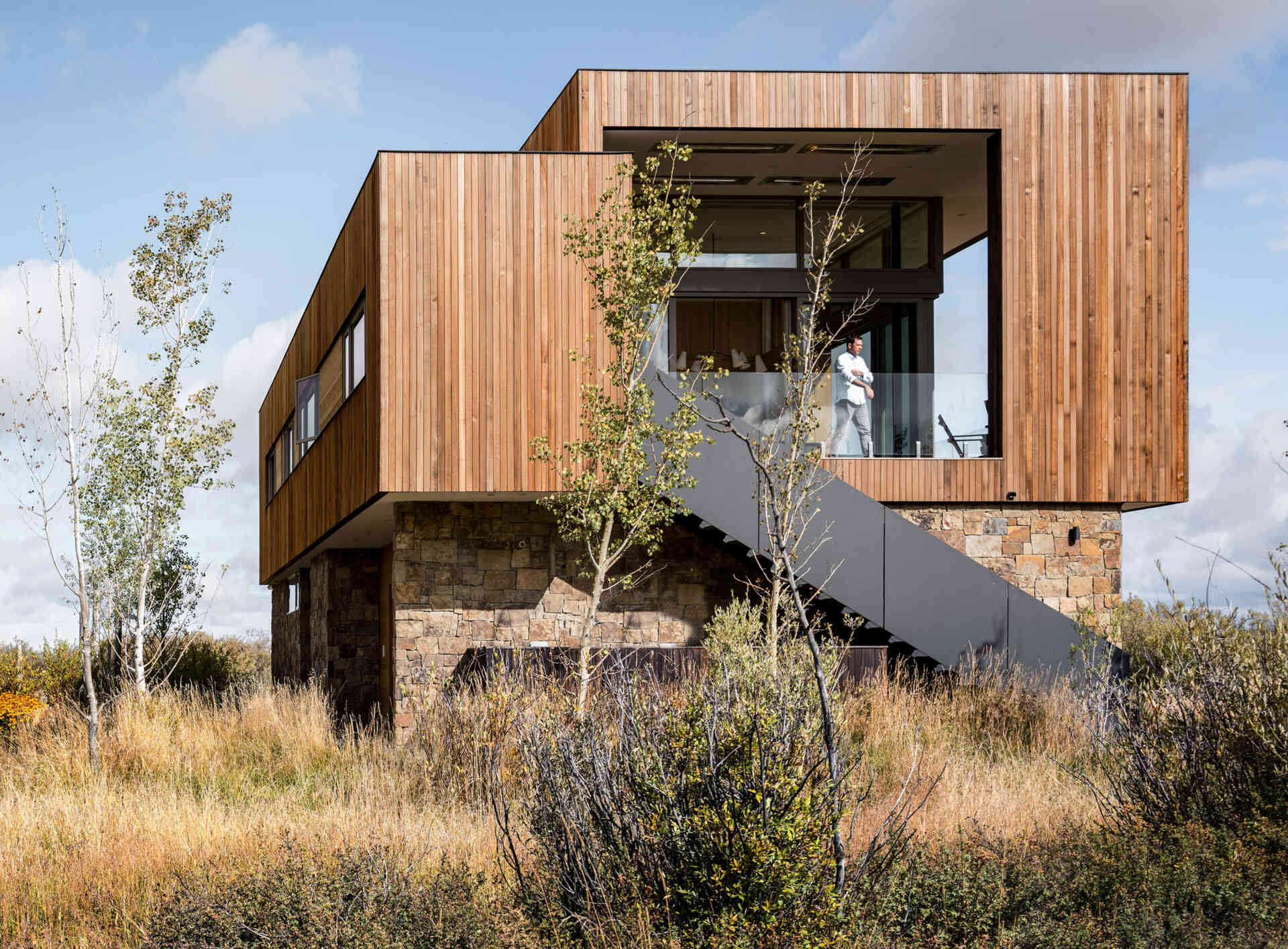 Earthen rock and stained wood connect this contemporary home to its natural Idaho surroundings.