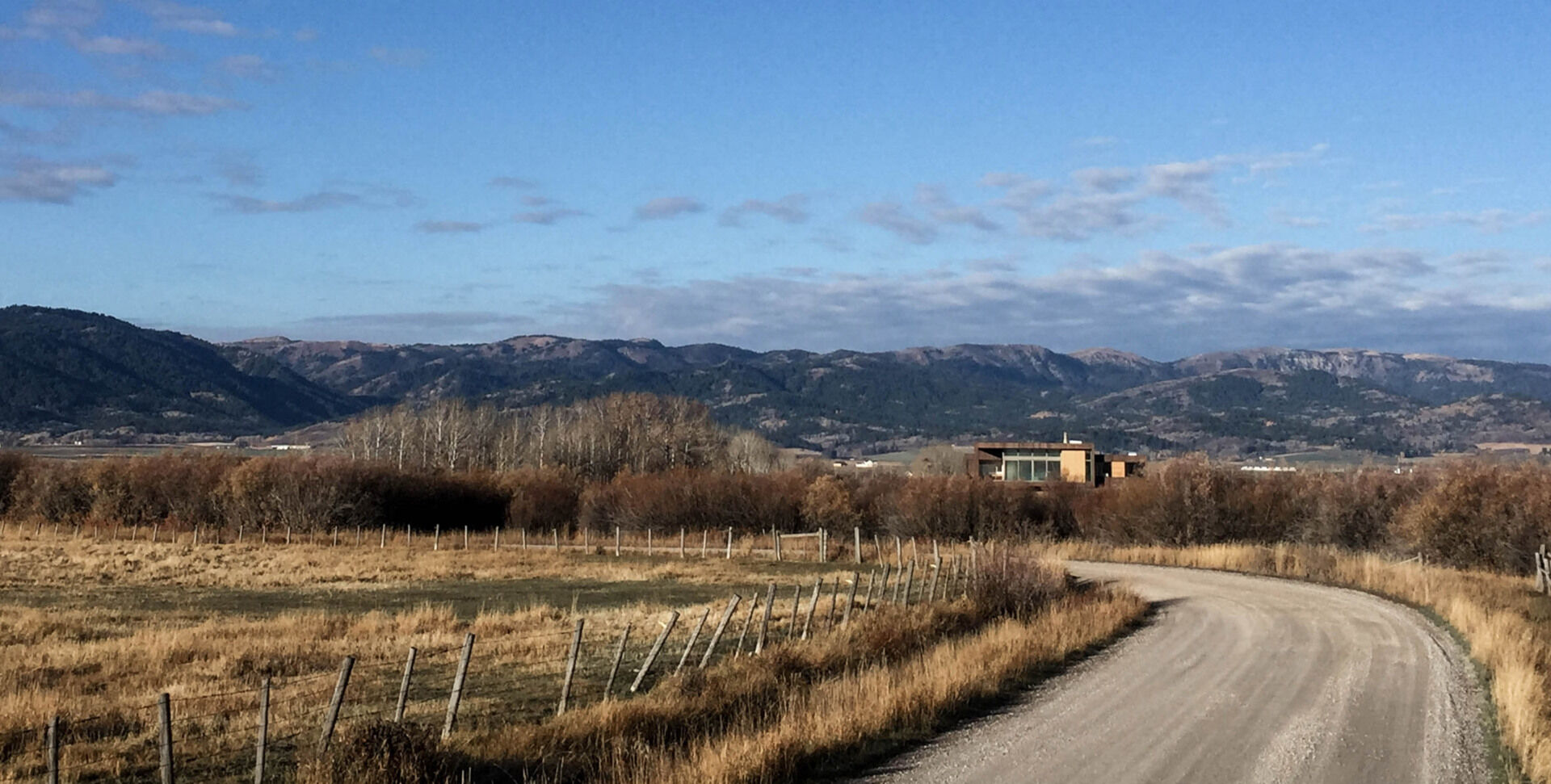 Earthen rock and stained wood connect this contemporary home to its natural Idaho surroundings.