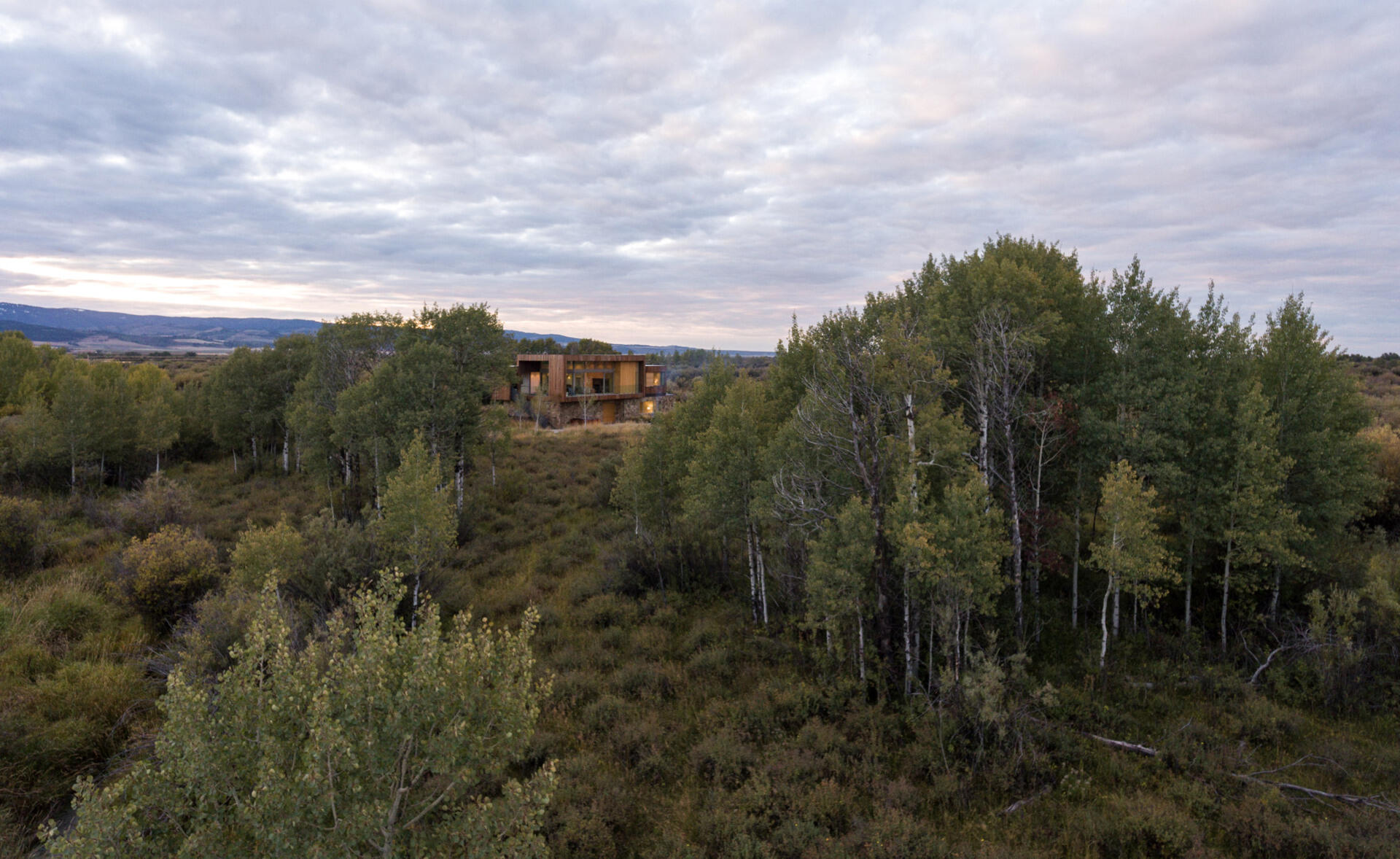 Earthen rock and stained wood connect this contemporary home to its natural Idaho surroundings.