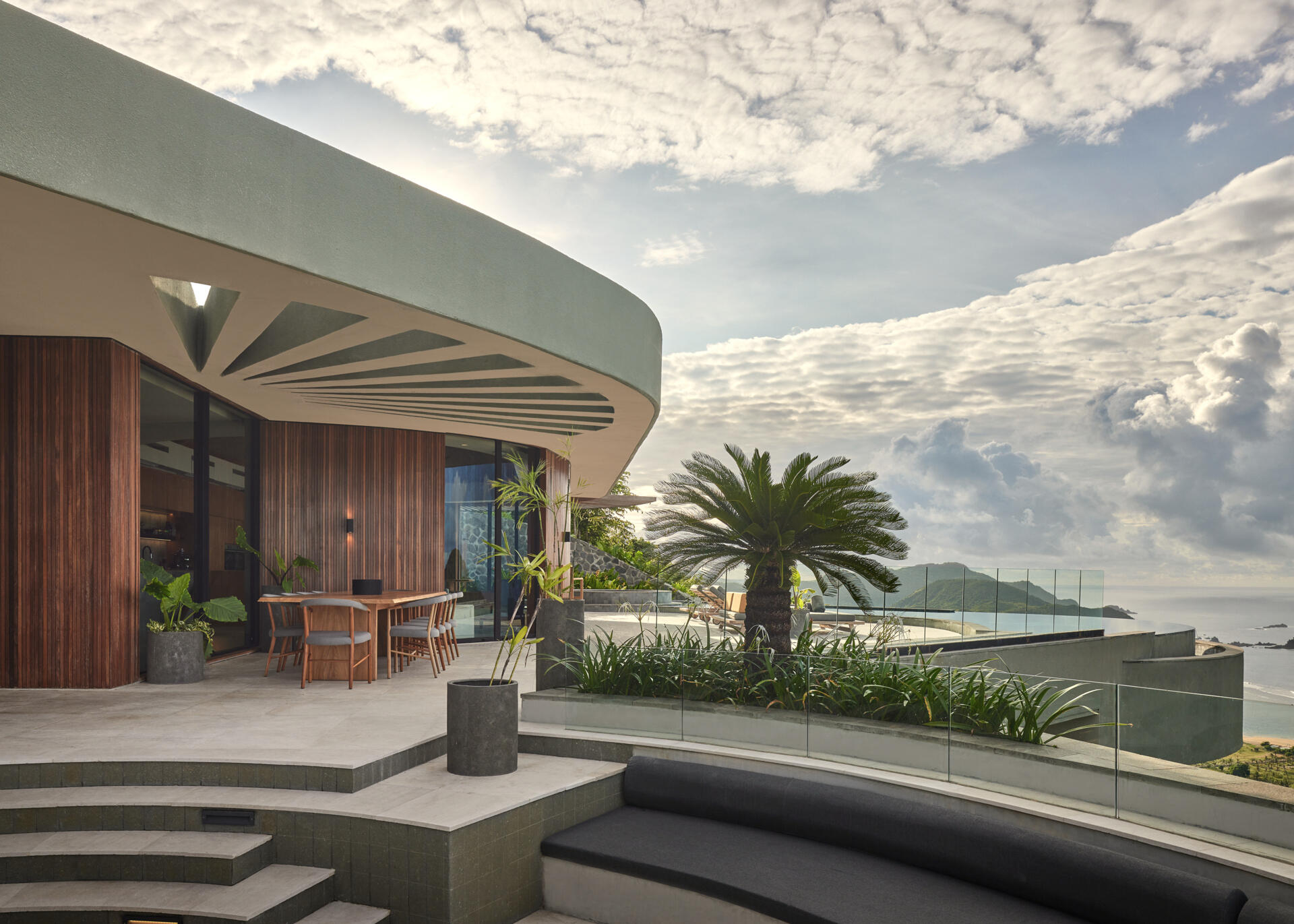 Outdoor dining spaces follow the same circular planning, connecting food, views, and landscape without sharp boundaries.