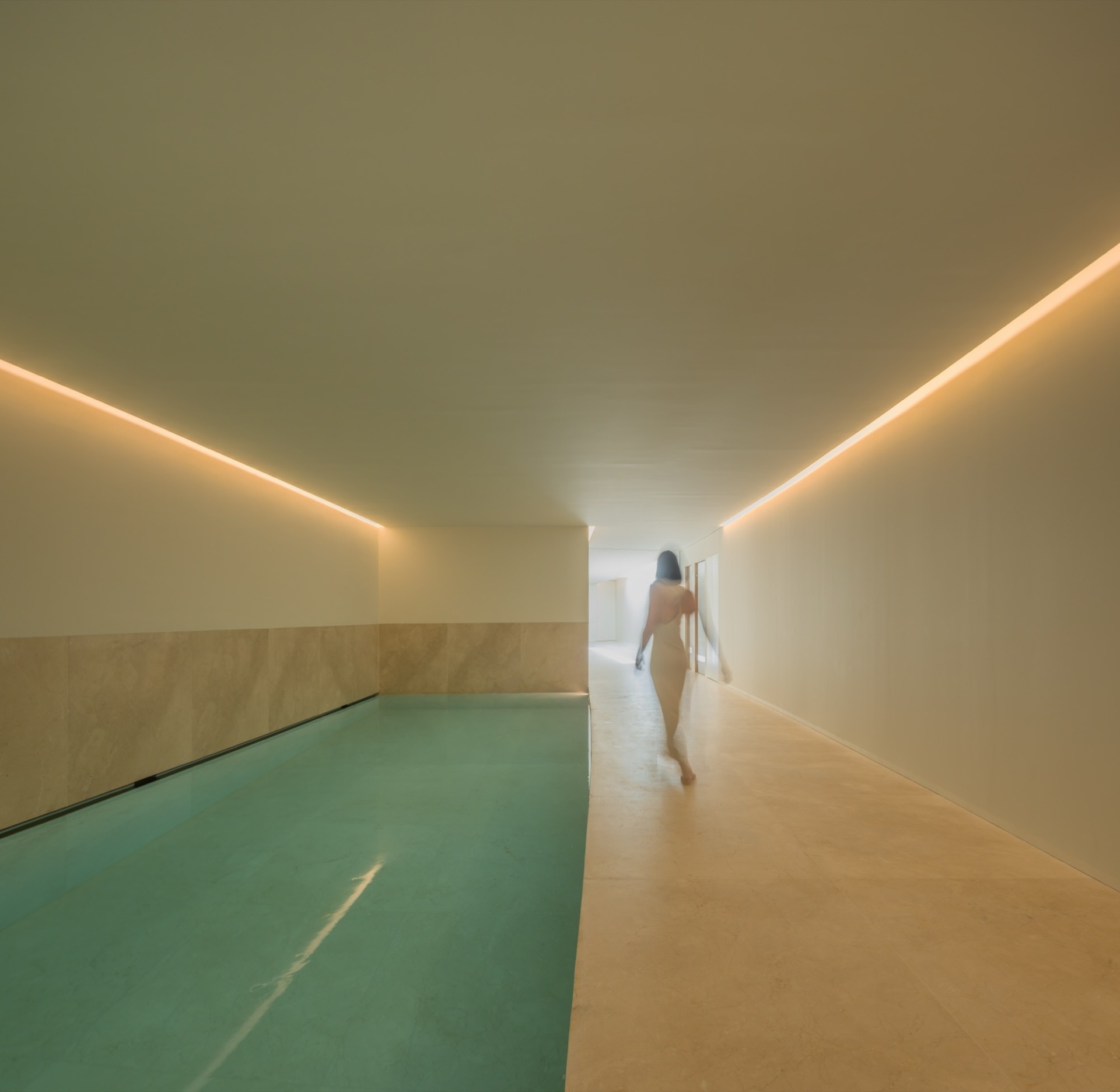 An indoor pool is included within this modern home and is positioned according to the same ascending layout as the rest of the house.