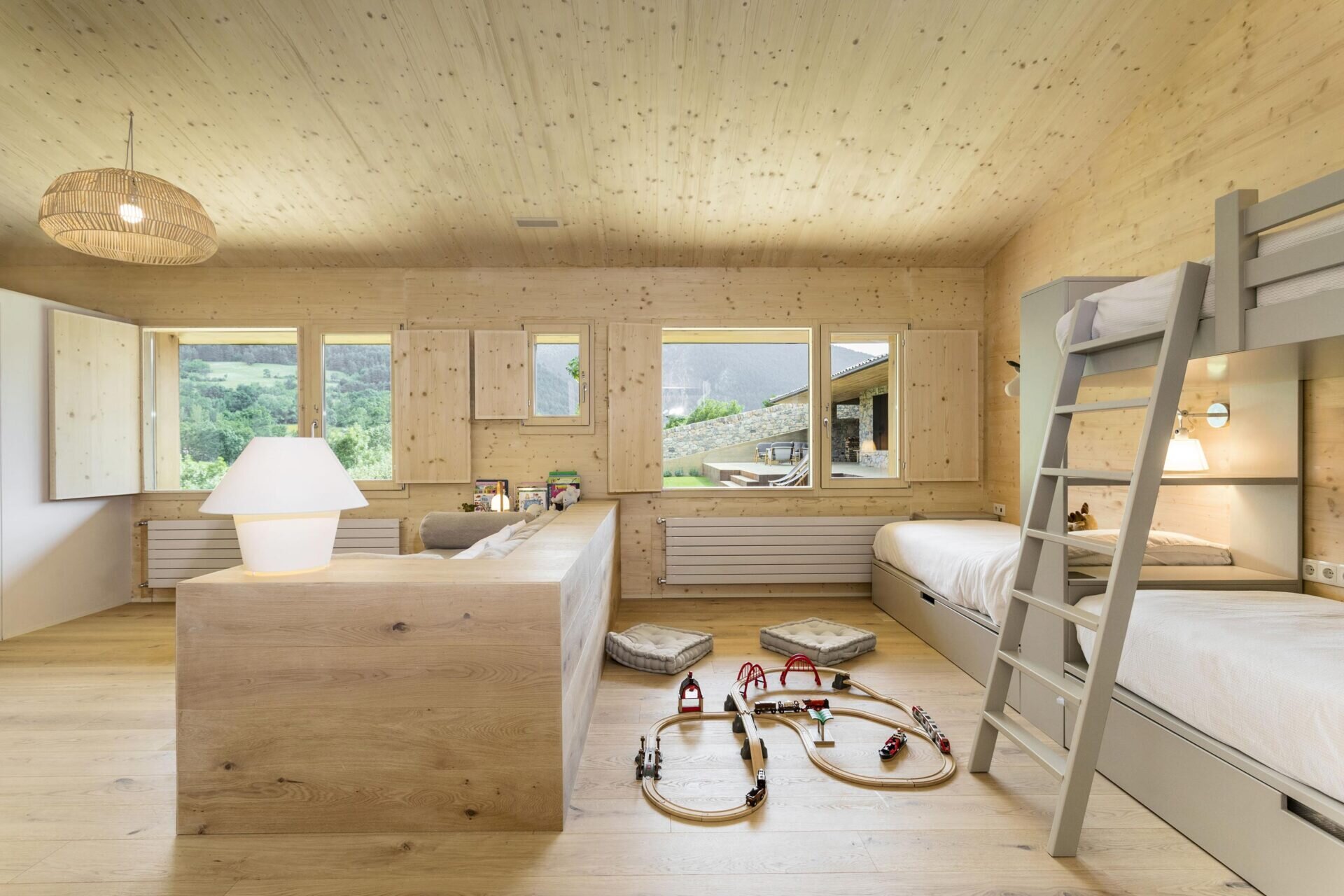 Bunk beds and a pony wall create separate sleeping and play zones in the children’s bedroom.