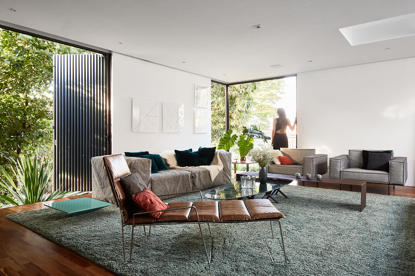 A secondary living room designed as a quieter retreat. Here, the exterior miniwave panels play a crucial role, controlling sunlight, acoustics, and security while allowing flexibility in how the house engages with its surroundings. The facade becomes both a protective layer and a tool for comfort.