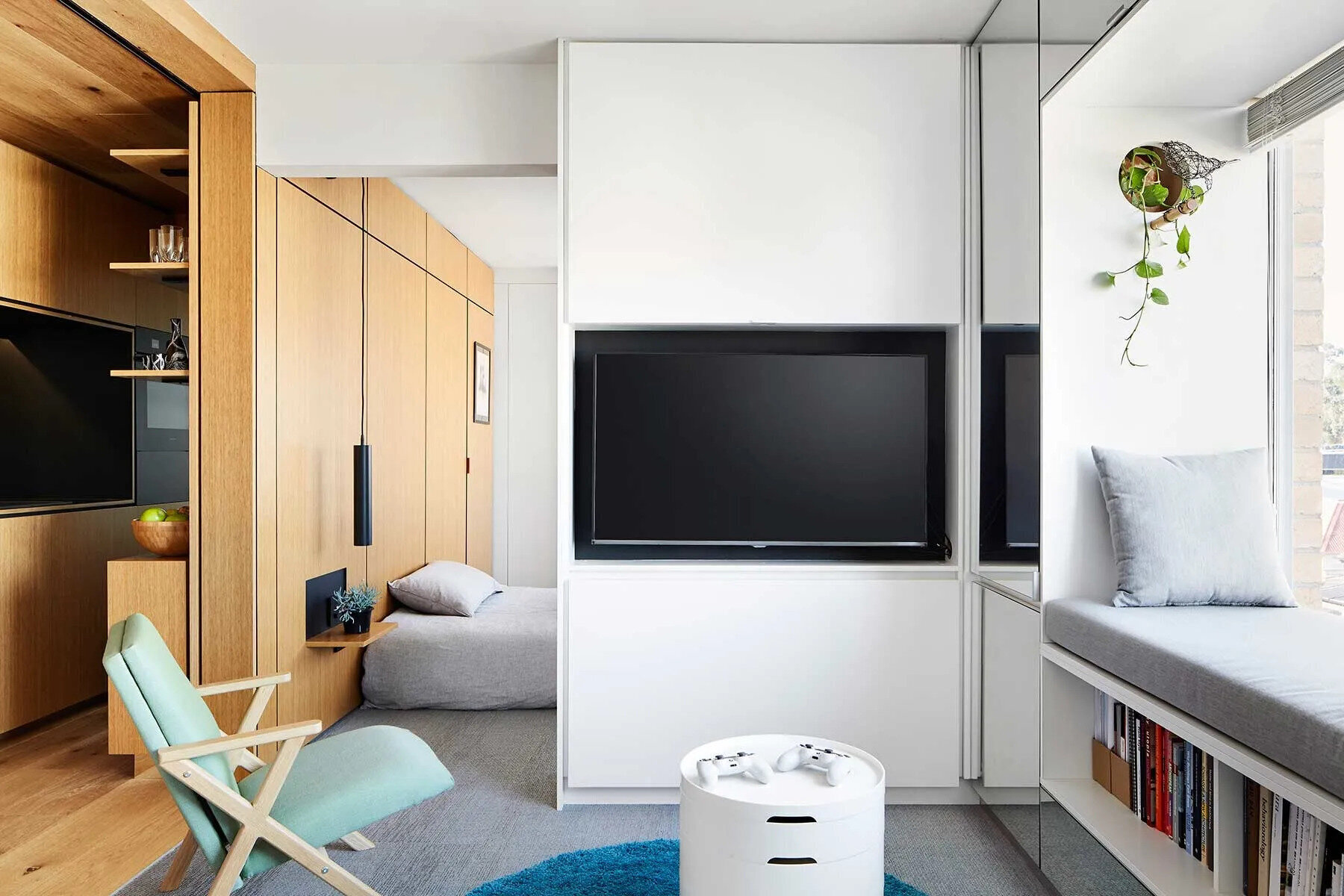 Hidden behind cabinetry, this living room doubles as a home office, allowing work tools to disappear completely when not in use.