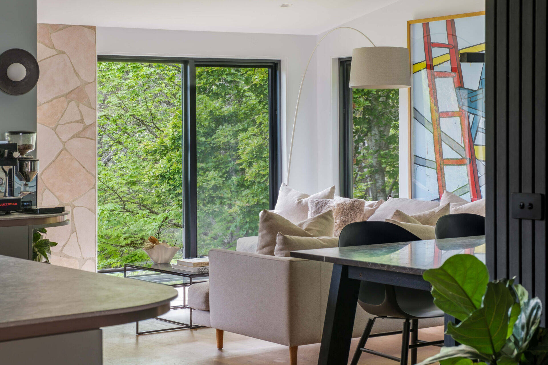 A warm living room anchored by a nostalgic stone hearth and framed by beautiful natural light.