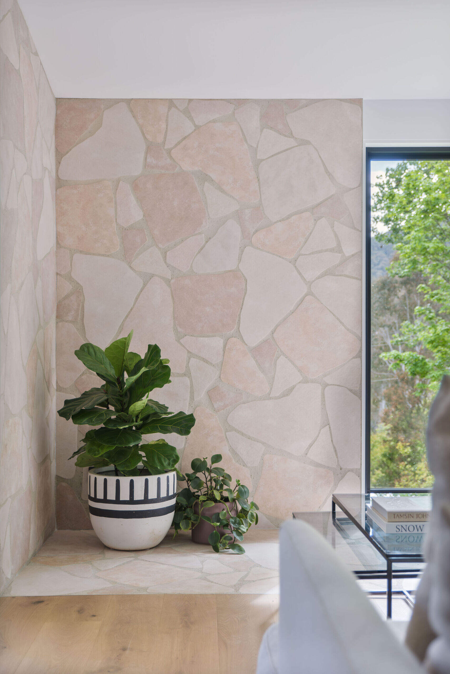 A warm living room anchored by a nostalgic stone hearth and framed by beautiful natural light.