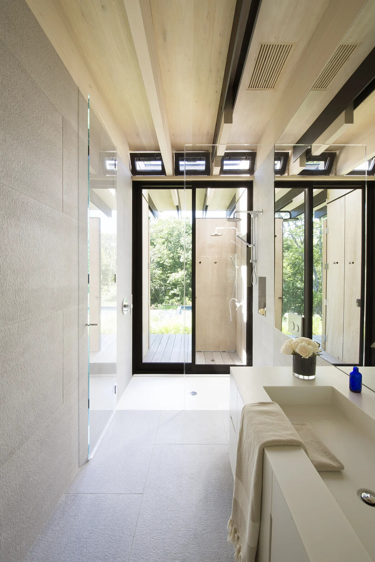 An indoor and outdoor shower setup makes post ocean clean ups effortless in this water loving Hamptons home.