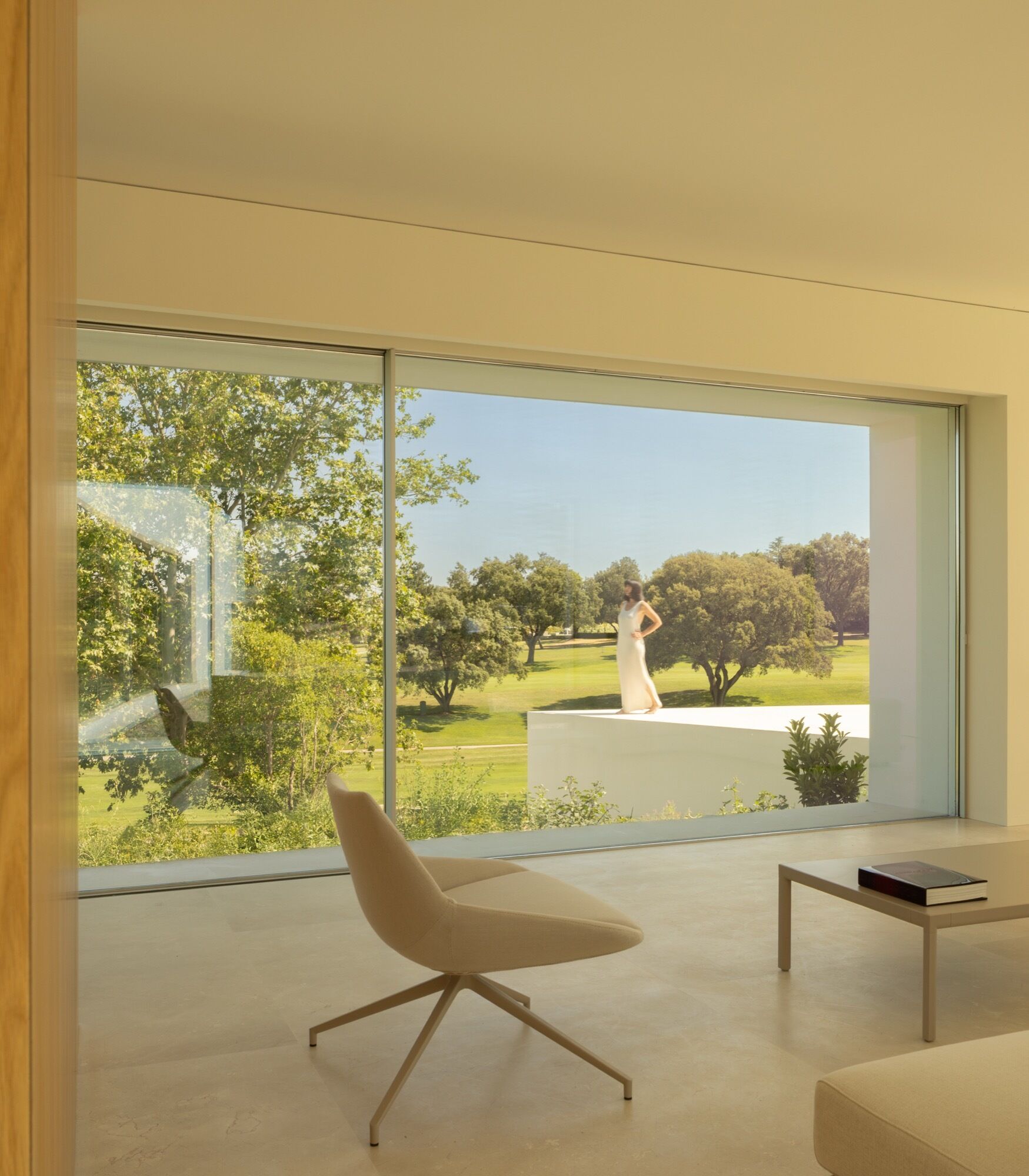 A minimalist living room with oversized windows.
