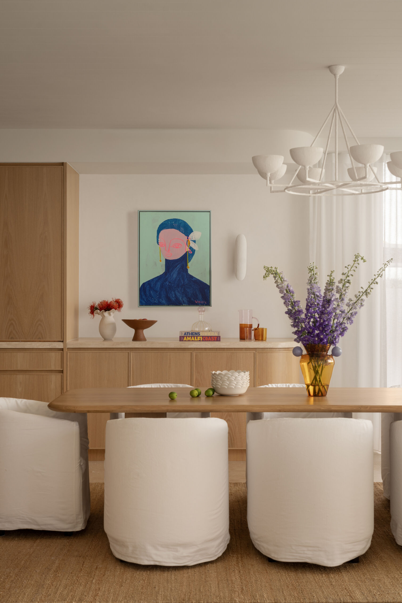 A serene dining area bridging the kitchen and outdoor spaces with warm textures and relaxed elegance.