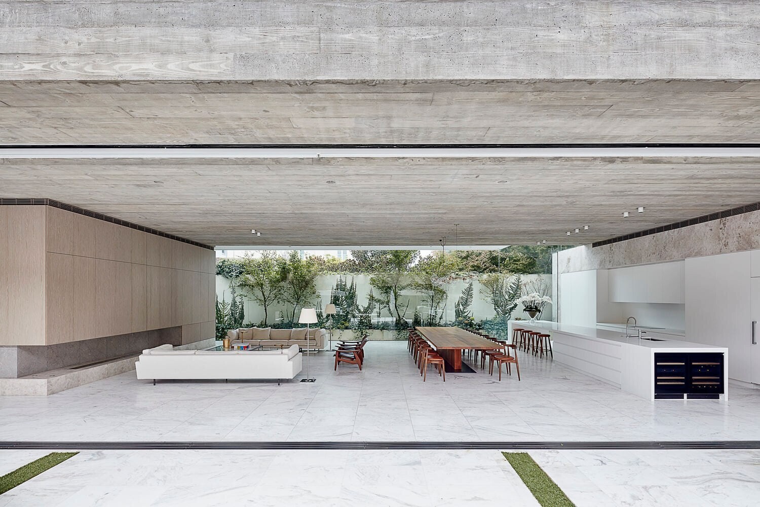 An expansive open plan living space connects kitchen, dining and lounge areas with seamless indoor outdoor flow.