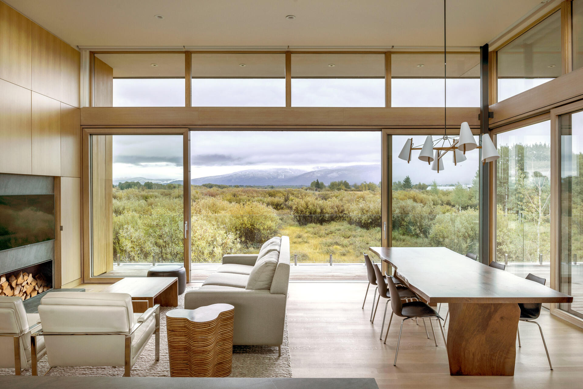 An elevated living space opens to a wrap around balcony overlooking wetlands and mountain views.