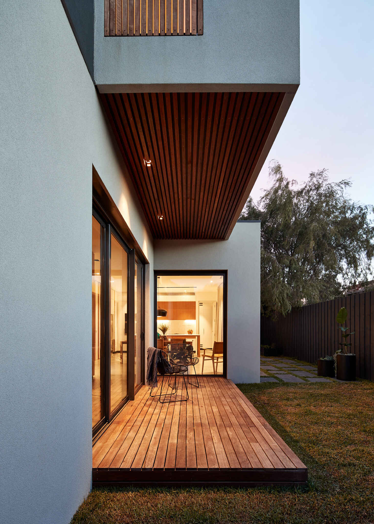 Sliding glass doors connect the living room to a deck and backyard, blurring the line between inside and out.