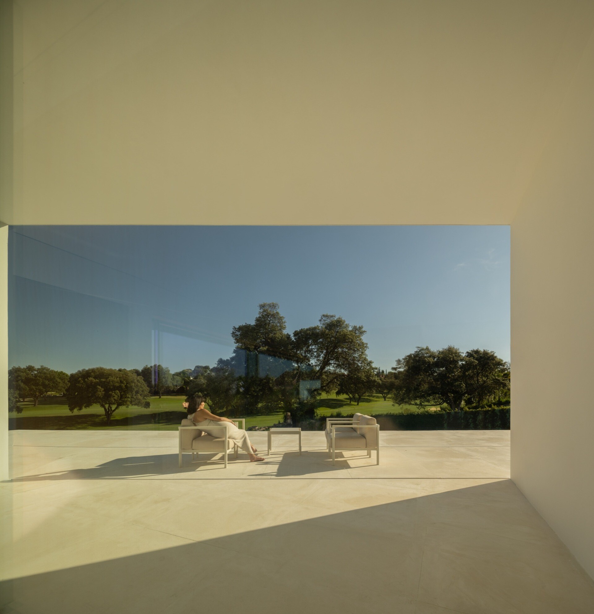 A minimalist home has a variety of patio areas and a shaded terrace.