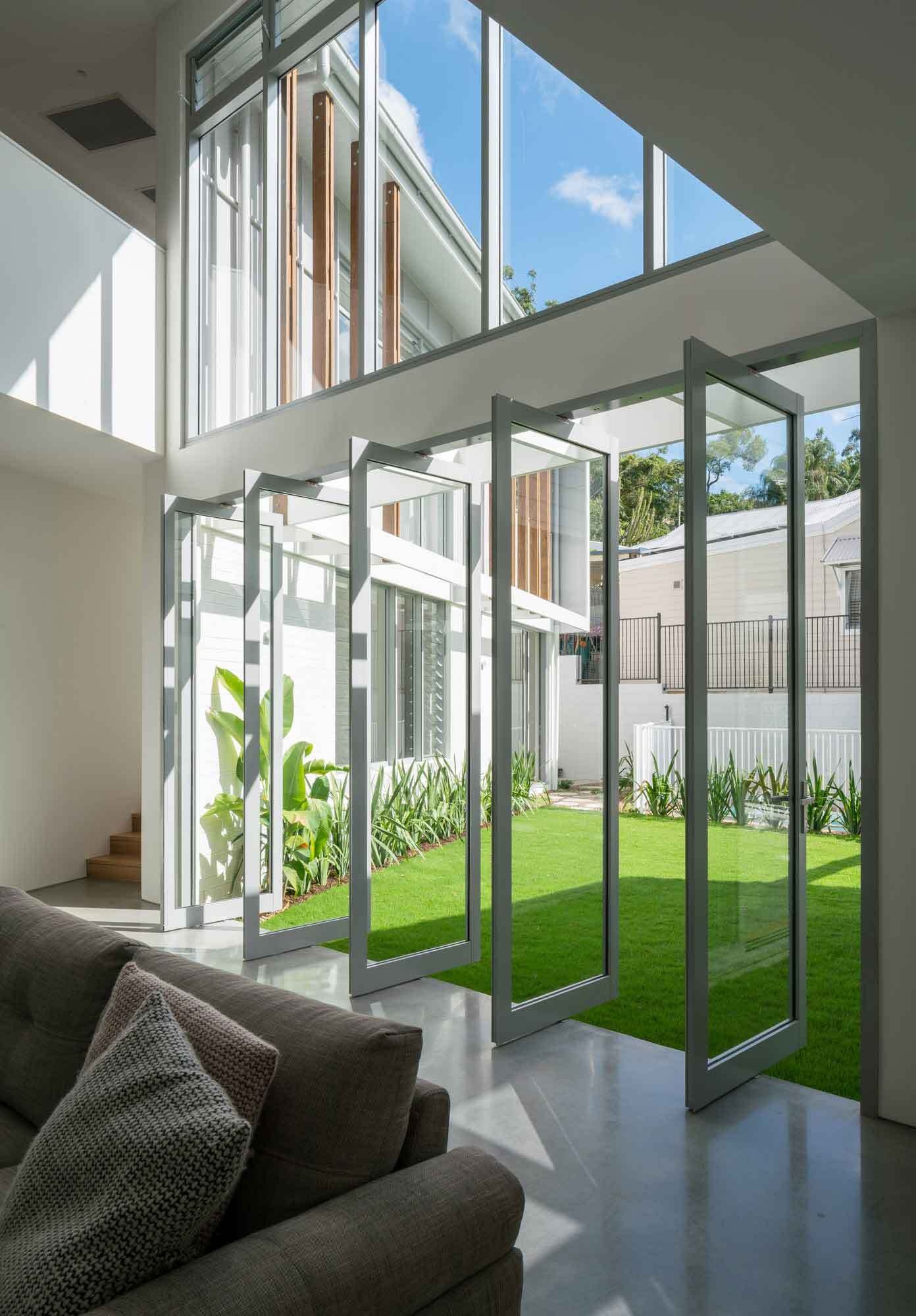 Pivoting glass doors blur the line between inside and outside, allowing light and breezes to flow through.