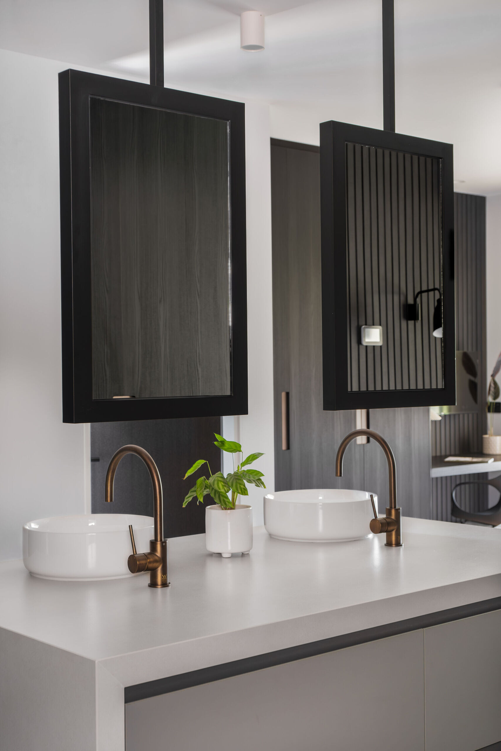A sculptural bathroom with emerald tiles, terrazzo floors and floating mirrors designed for an elevated daily experience.