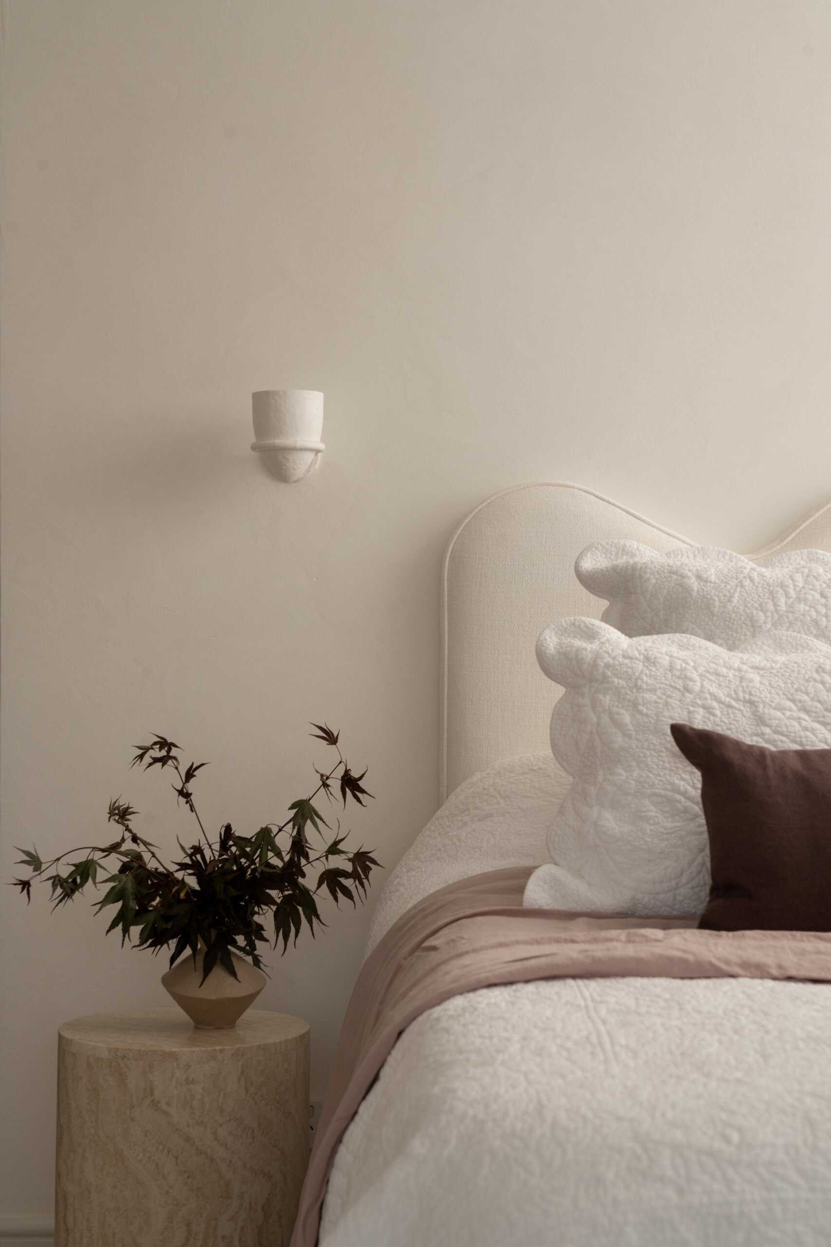 The primary suite is designed for unwinding. The bedroom stays understated and layered, with a calm presence that settles instantly. In the walk-in robe, a clean white scheme comes to life with warm lighting bouncing off subtle timber grain.