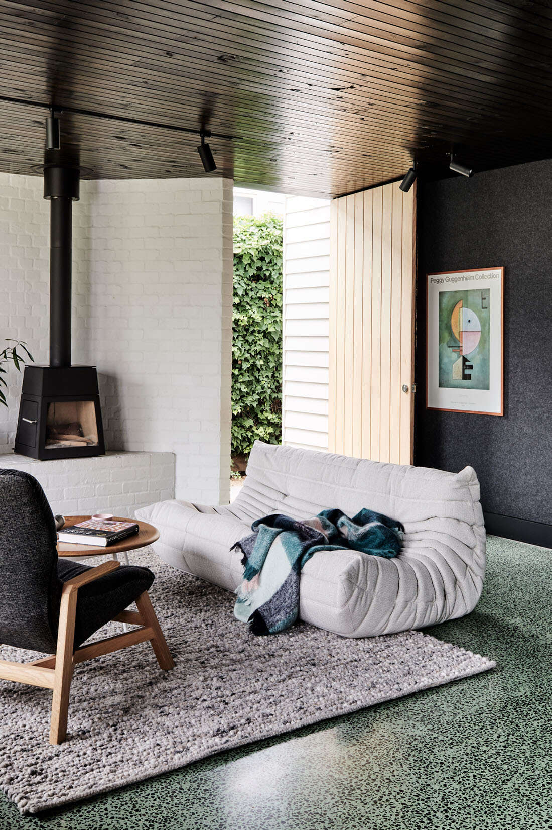 A sage green concrete floor flecked with bluestone brings bold color and smart thermal performance.