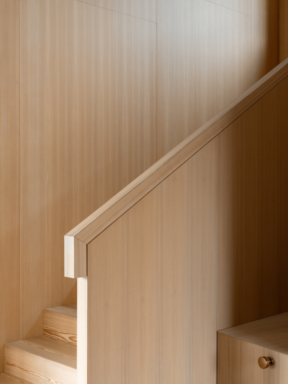 A wood clad stair and built in desk define an upper level study filled with light and cedarwood warmth.