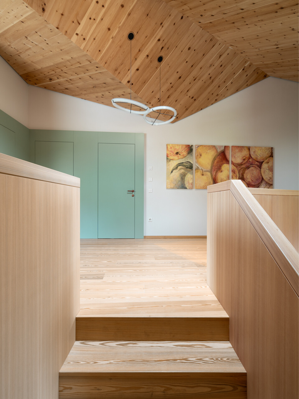 A wood clad stair and built in desk define an upper level study filled with light and cedarwood warmth.