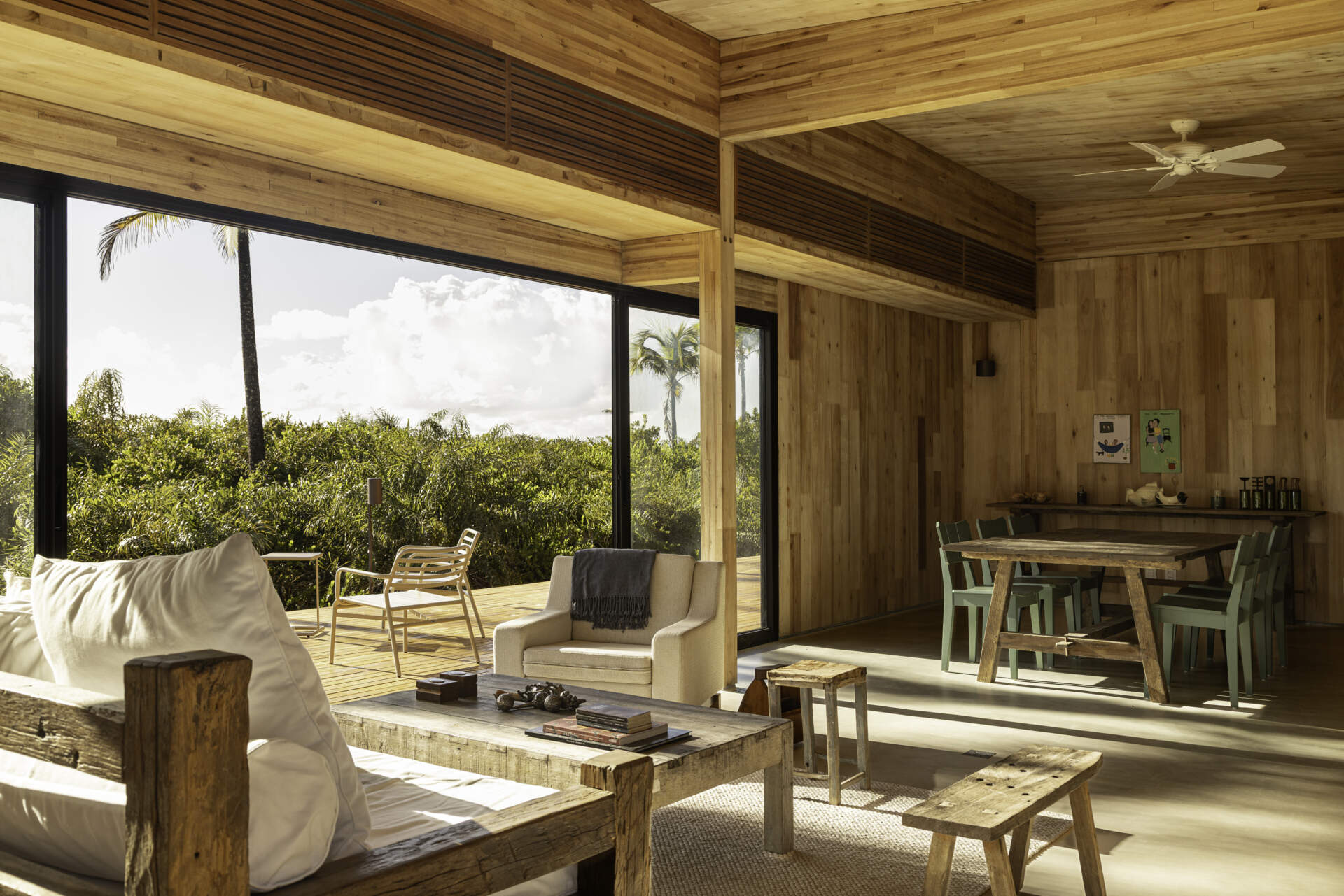 A modular home set between the river and the sea, designed for calm tropical living. Warm wood interiors, large glass openings, and open patios create a seamless flow between forest, coast, and indoor comfort.
