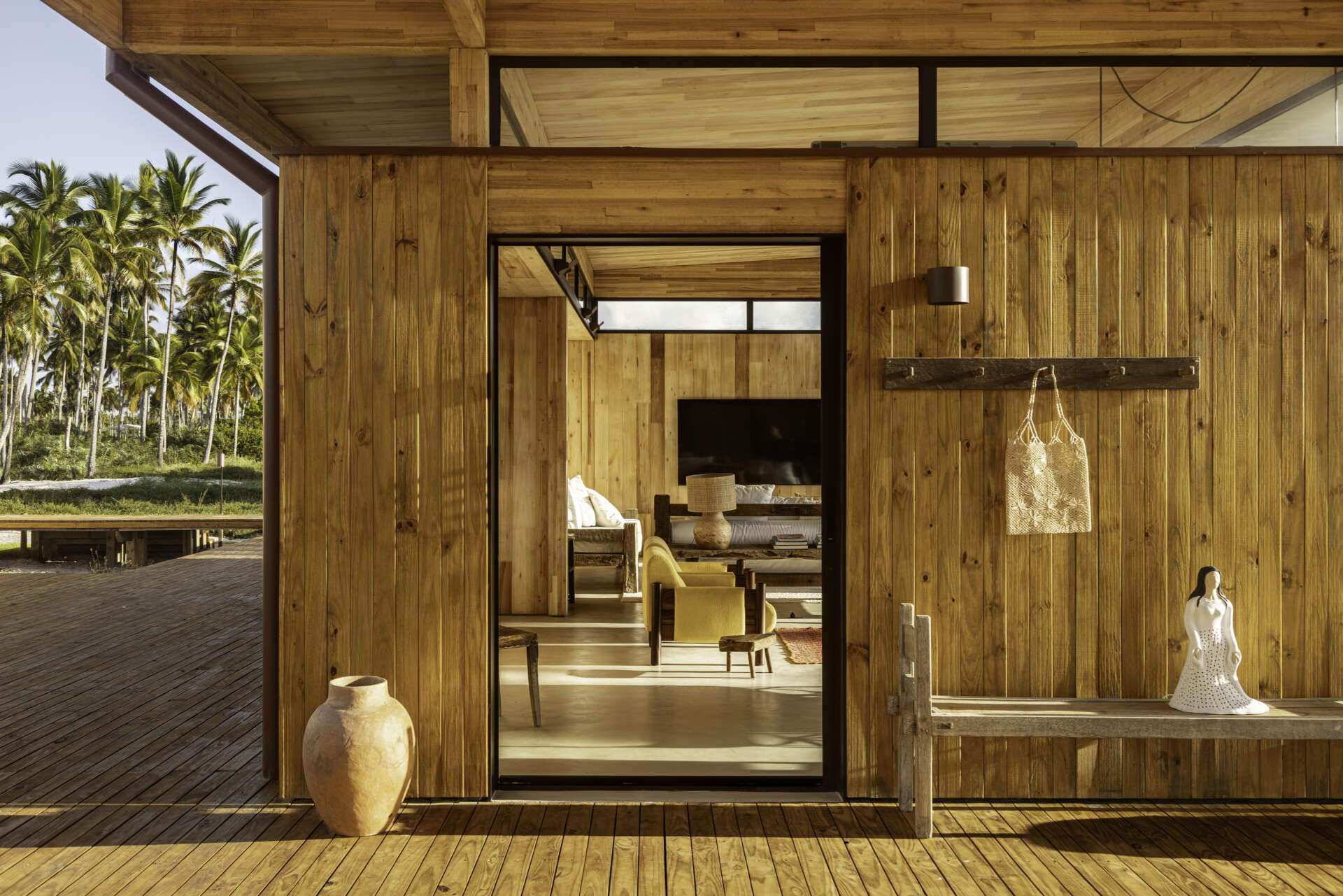 A modular home set between the river and the sea, designed for calm tropical living. Warm wood interiors, large glass openings, and open patios create a seamless flow between forest, coast, and indoor comfort.