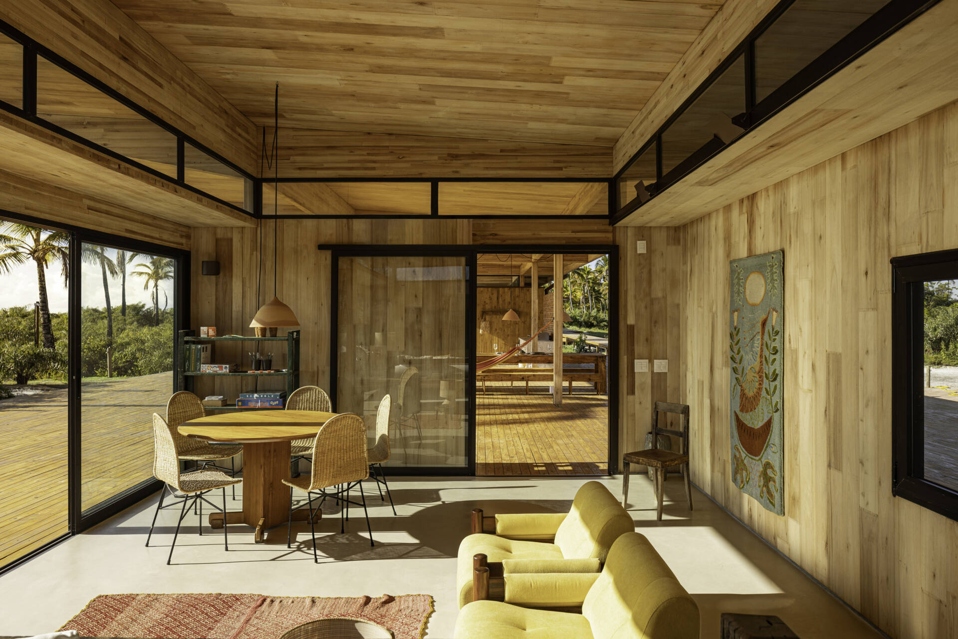 A modular home set between the river and the sea, designed for calm tropical living. Warm wood interiors, large glass openings, and open patios create a seamless flow between forest, coast, and indoor comfort.