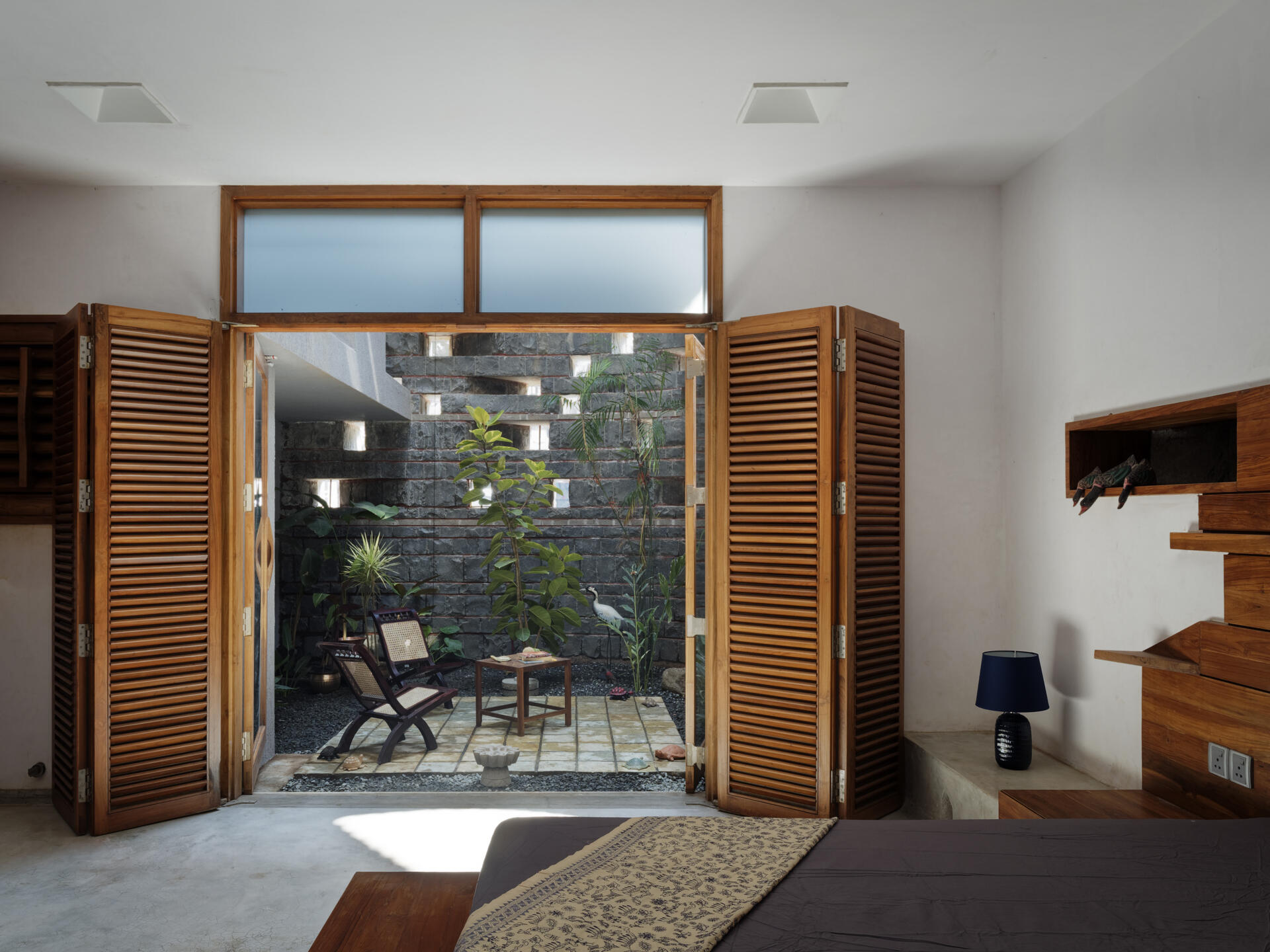 See the curved brick cutouts that act as both ornament and performance features, shaping airflow, shade, and character throughout the home.