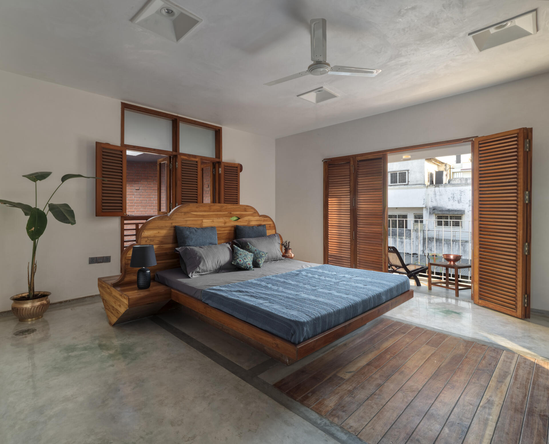 A bedroom in a sculptural brick home.