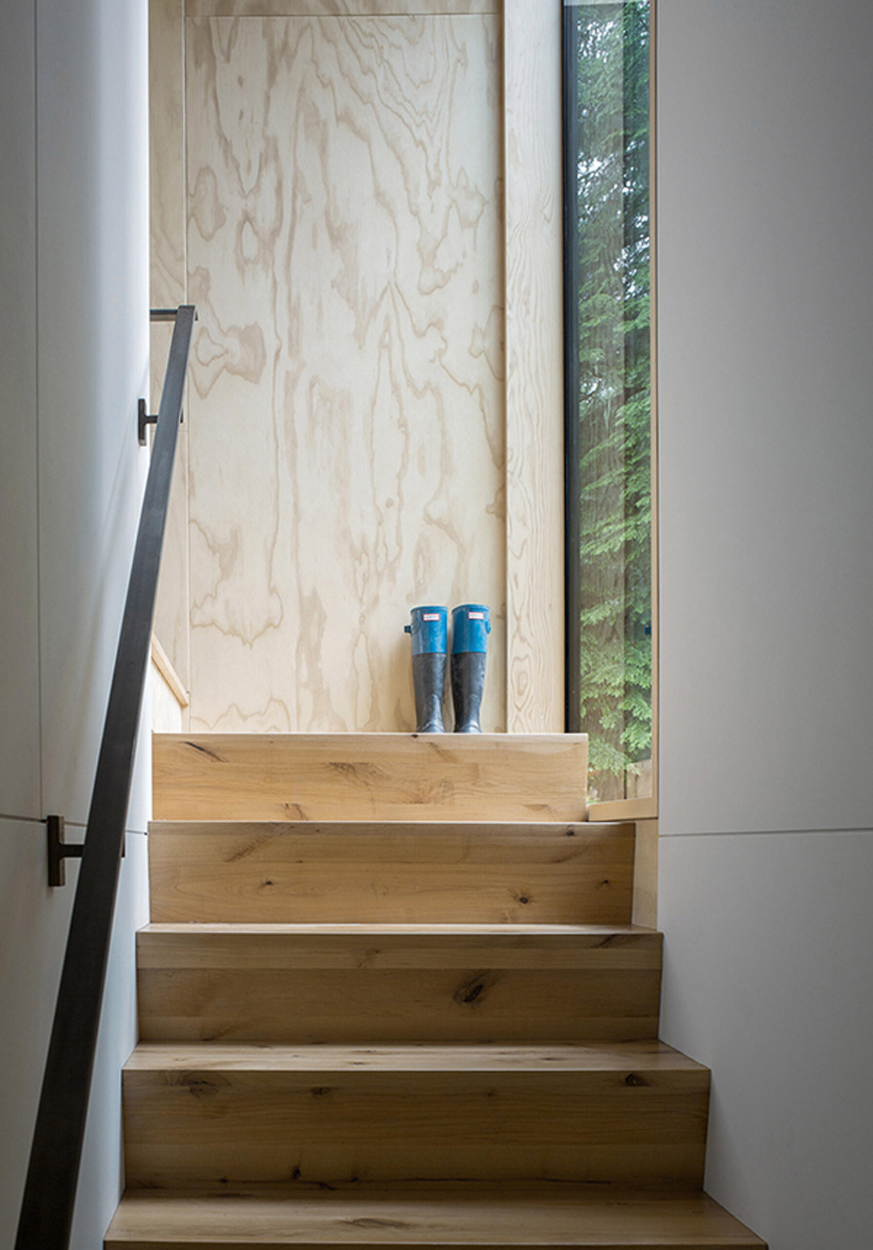 A soft wood staircase leads to the upper level that holds the bedroom and bathroom.