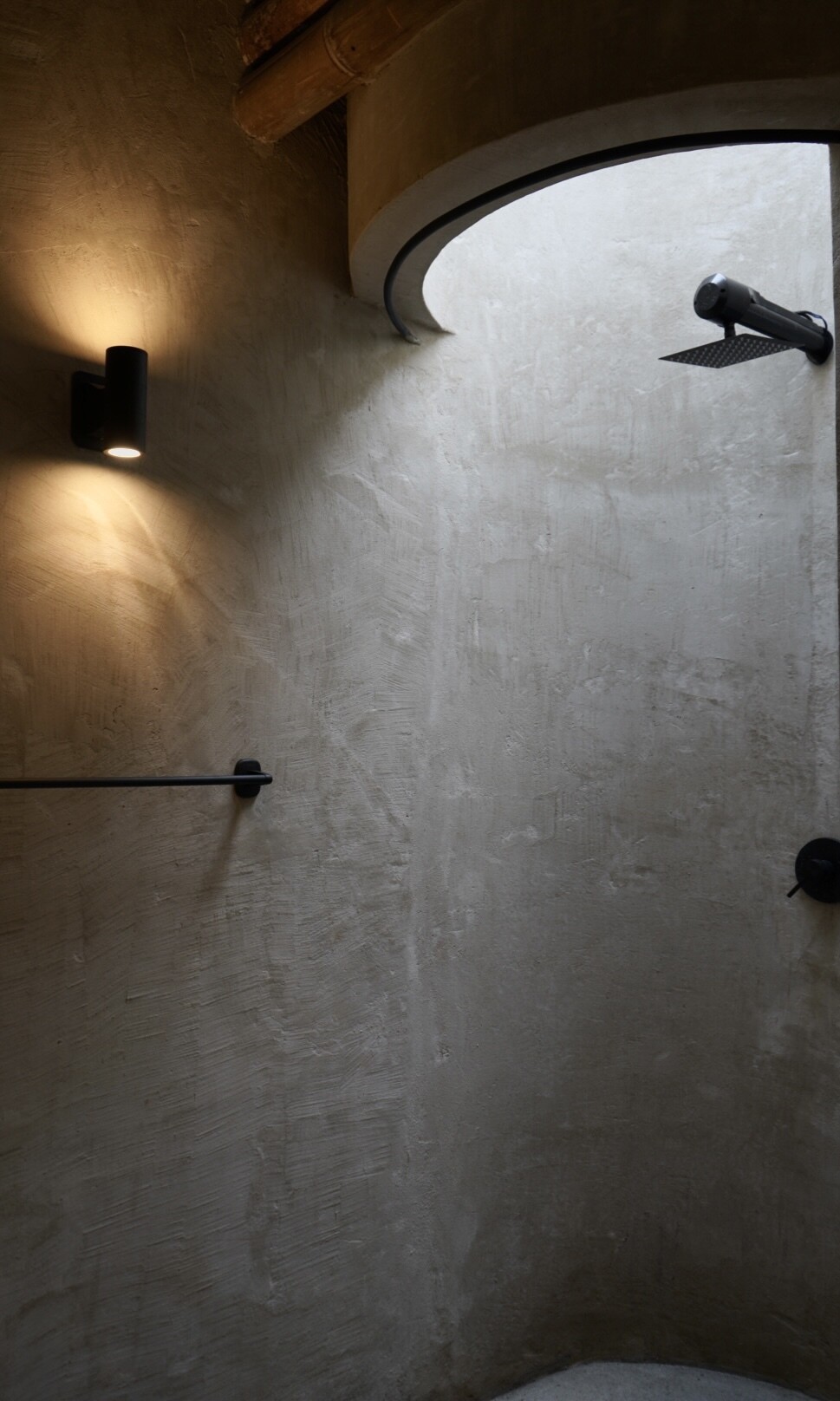 This Colombian home reimagines rural architecture with a butterfly roof that collects rainwater, bamboo-and-steel structural details, and an open interior where the bedroom, kitchenette, and a hidden curved-wall bathroom blend seamlessly, creating a sustainable, modern, and deeply connected living experience.