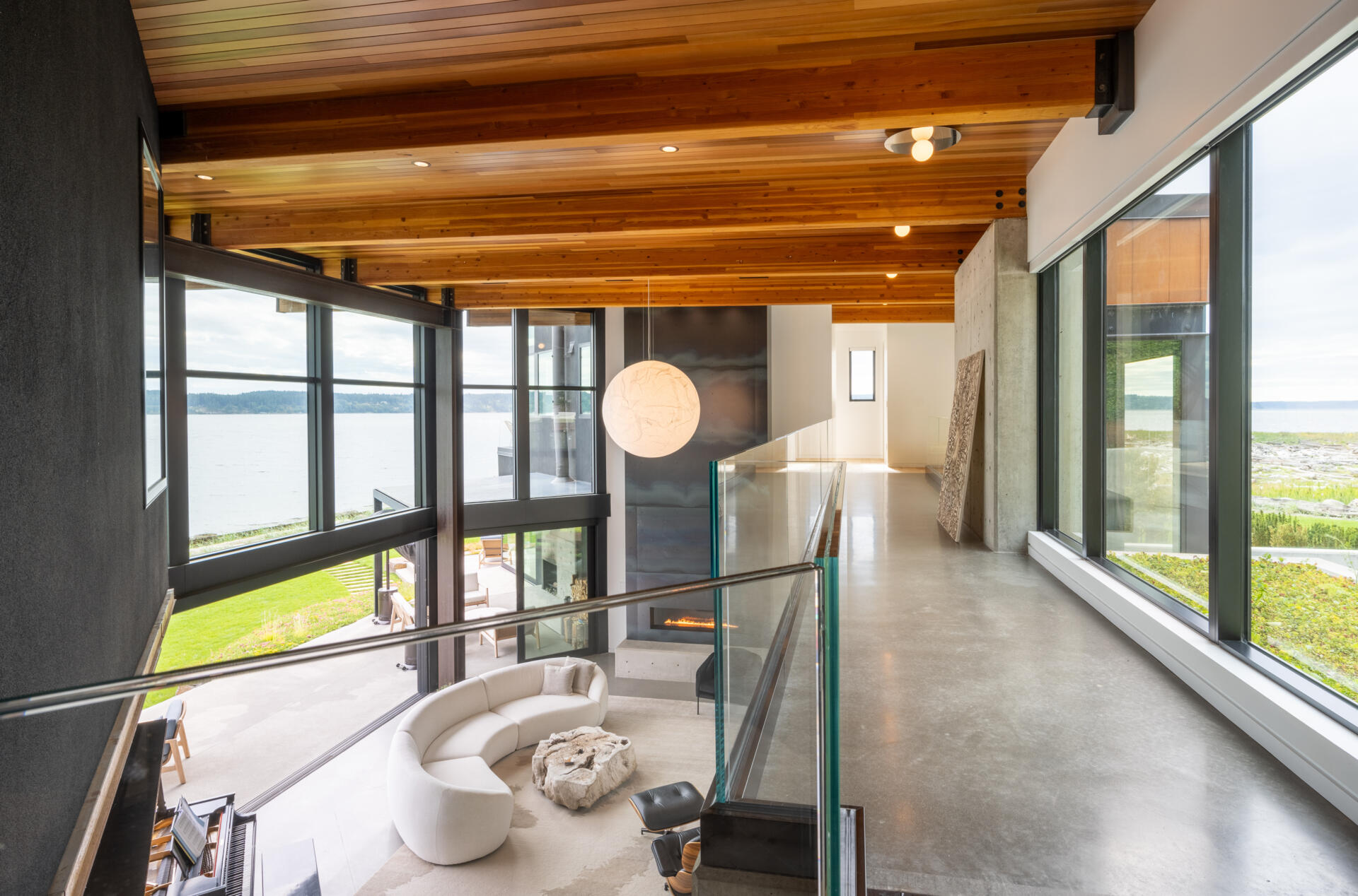 An interior bridge connects the north and south wings of this home. From this vantage point, the green roof above the entry becomes a prominent visual element. The bridge reinforces the sense of movement and connection throughout the home.