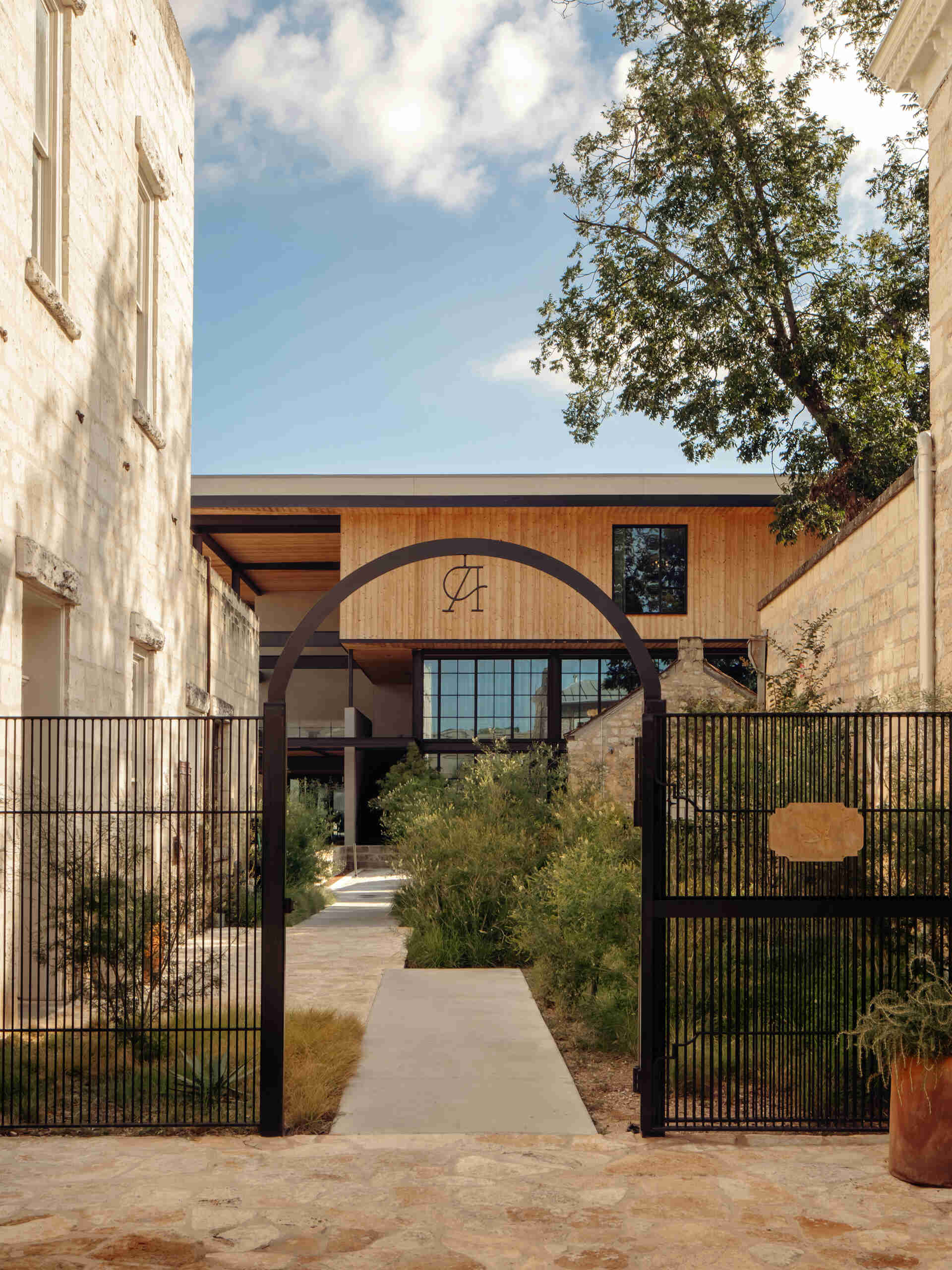 Historic streetfront buildings remain intact while new hotel architecture is quietly positioned behind, preserving the rhythm of downtown Fredericksburg.