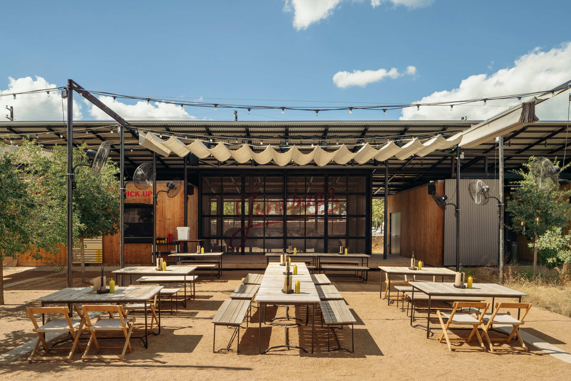 A two acre hotel property organized around gardens, paths, and outdoor connections rather than enclosed corridors.